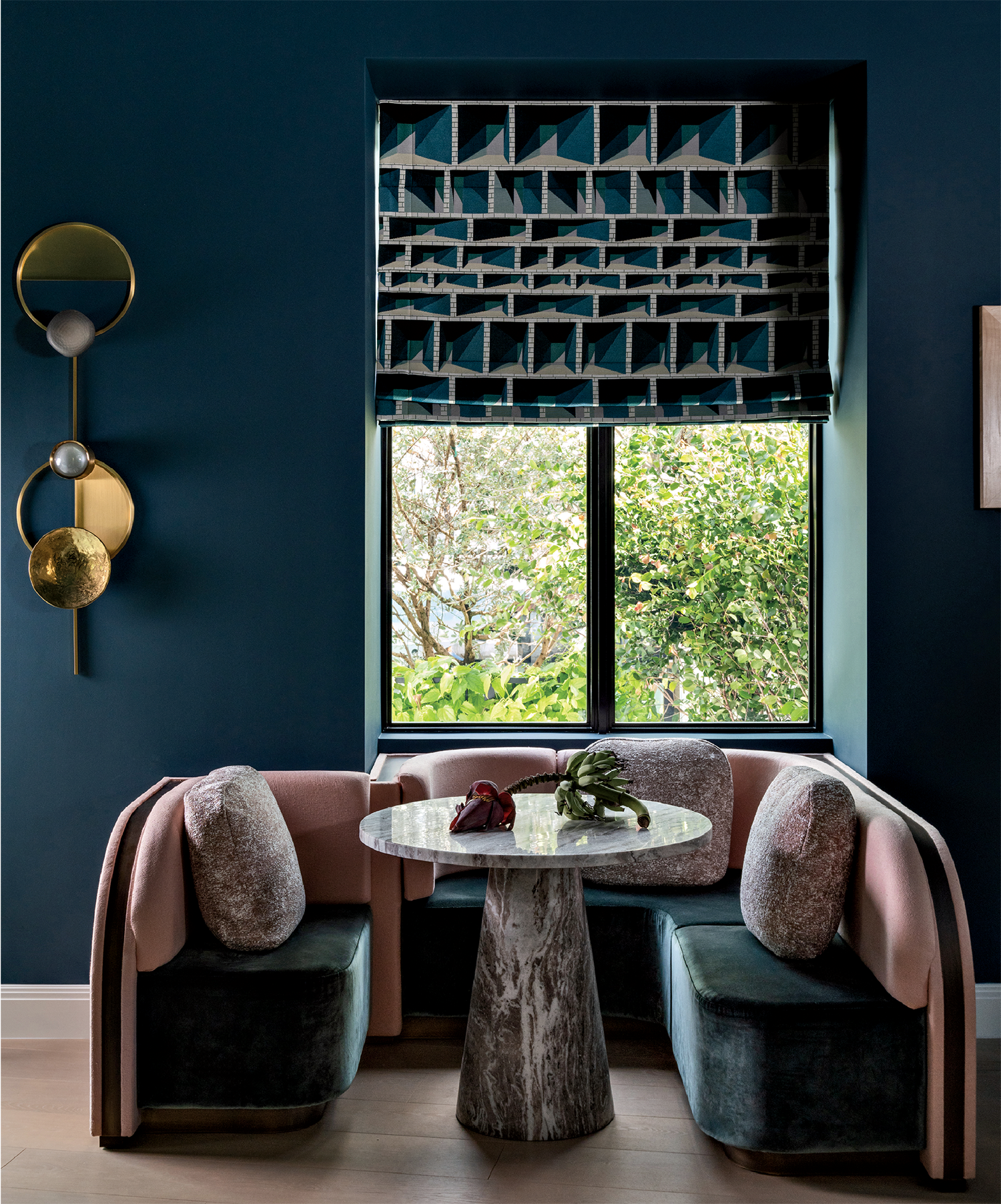 velvet banquette seating in a moody home bar 