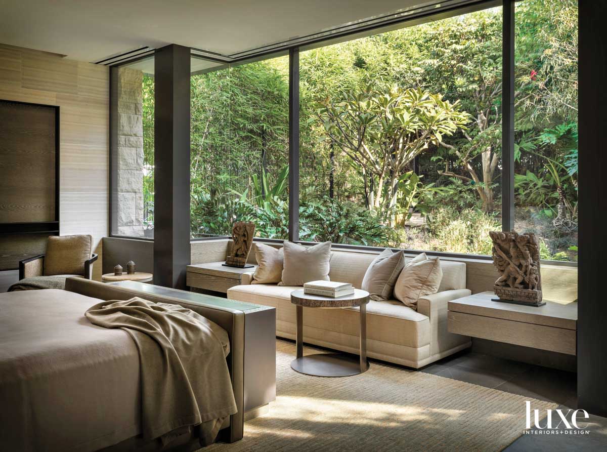 Detail of bedroom with bed facing a white sofa