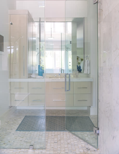 A modern bathroom featuring a glass shower door and a sleek sink.