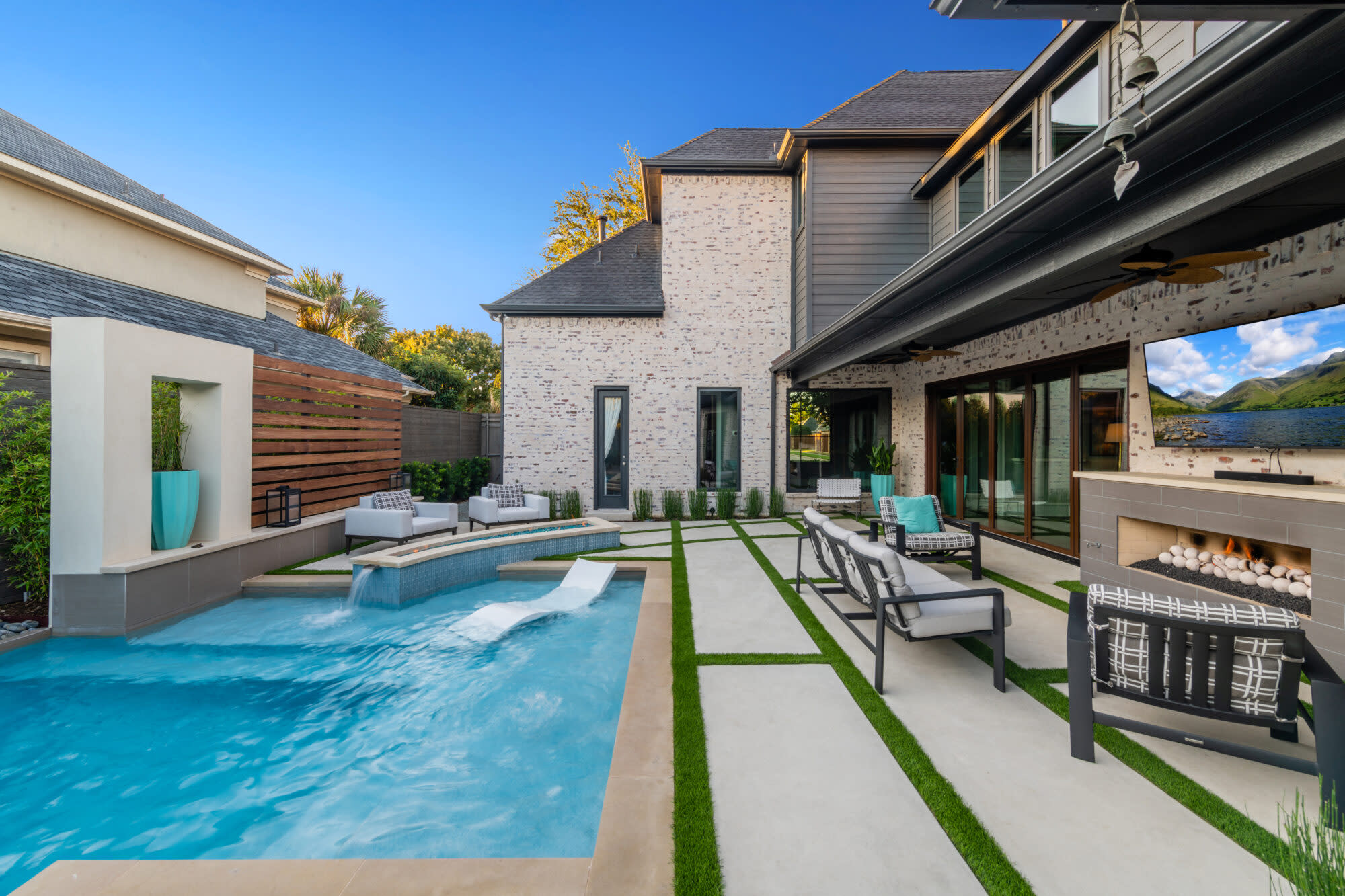 Modern pool with lounge shelf, linear pavers, and outdoor living space