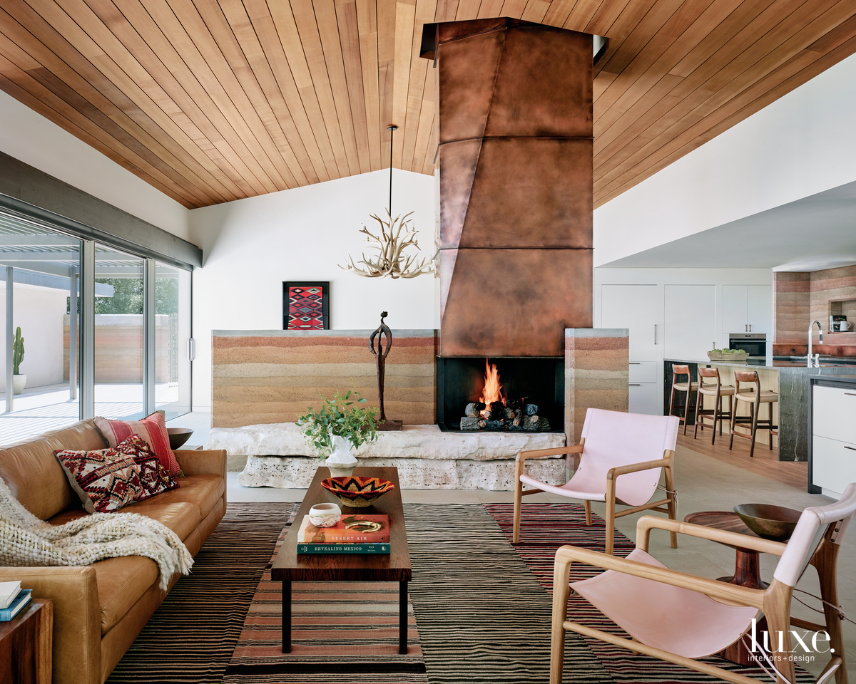 modern living room neutral palette pink chairs fireplace