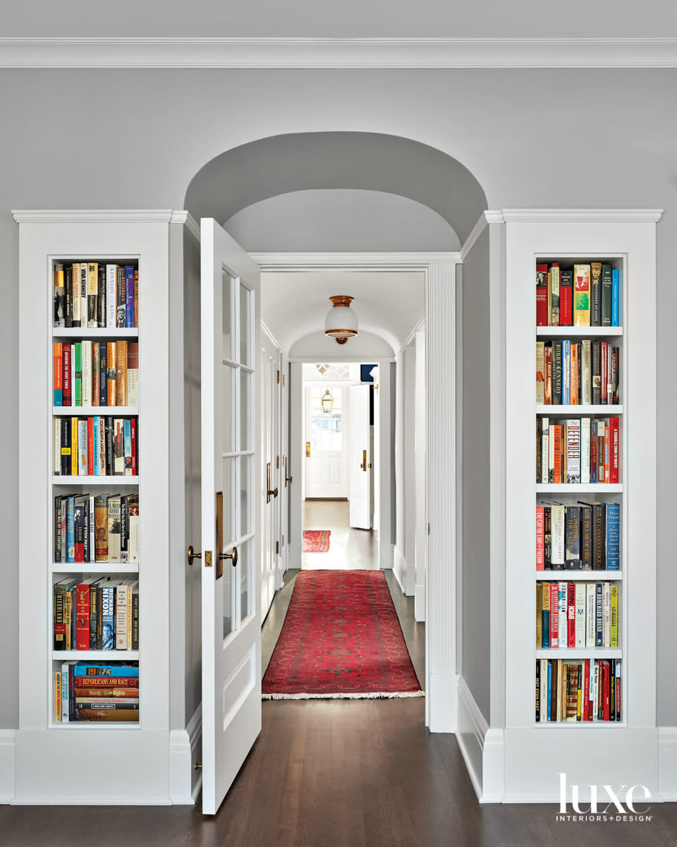 A hallway entrance with bookshelves on either side.