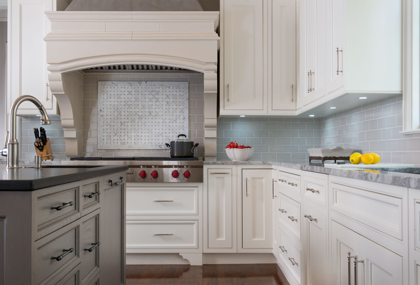 A bright kitchen showcasing elegant white cabinetry and a contrasting black countertop, exemplifying modern design.