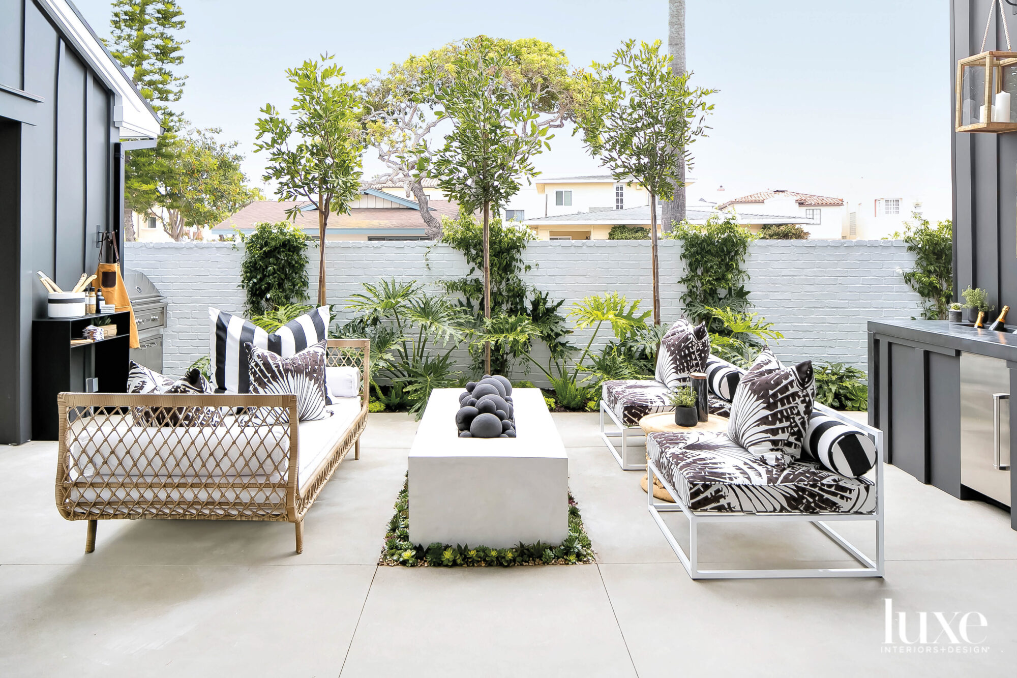 Patio with two settees facing a fire feature