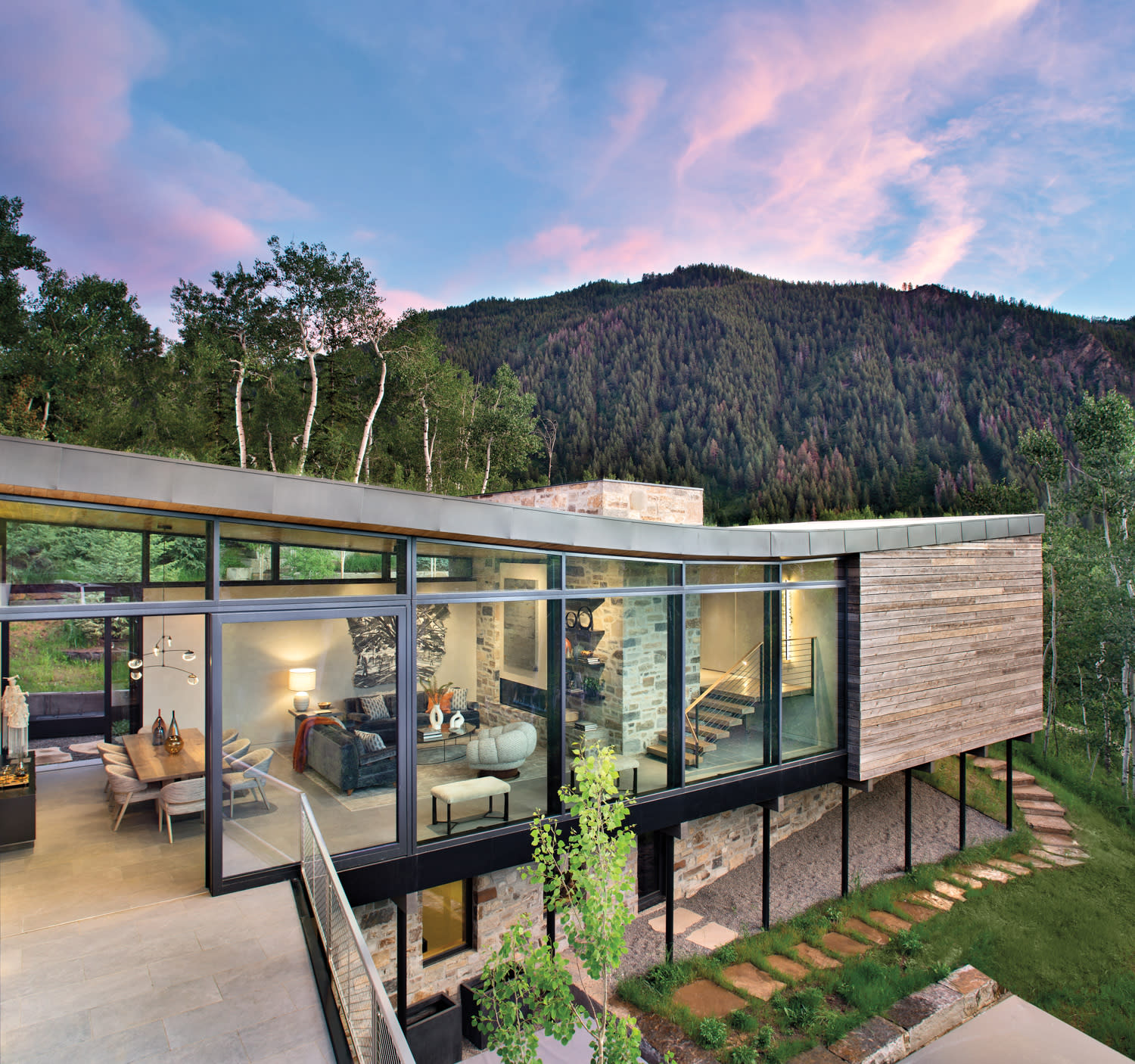 exterior view of home by Eugenia Jesberg with glass walls and mountain view in background