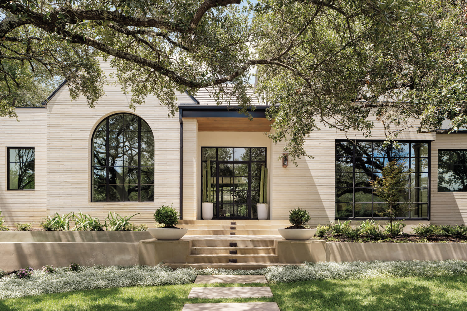 contemporary exterior facade featuring limestone patios in home by Cori Pfaff