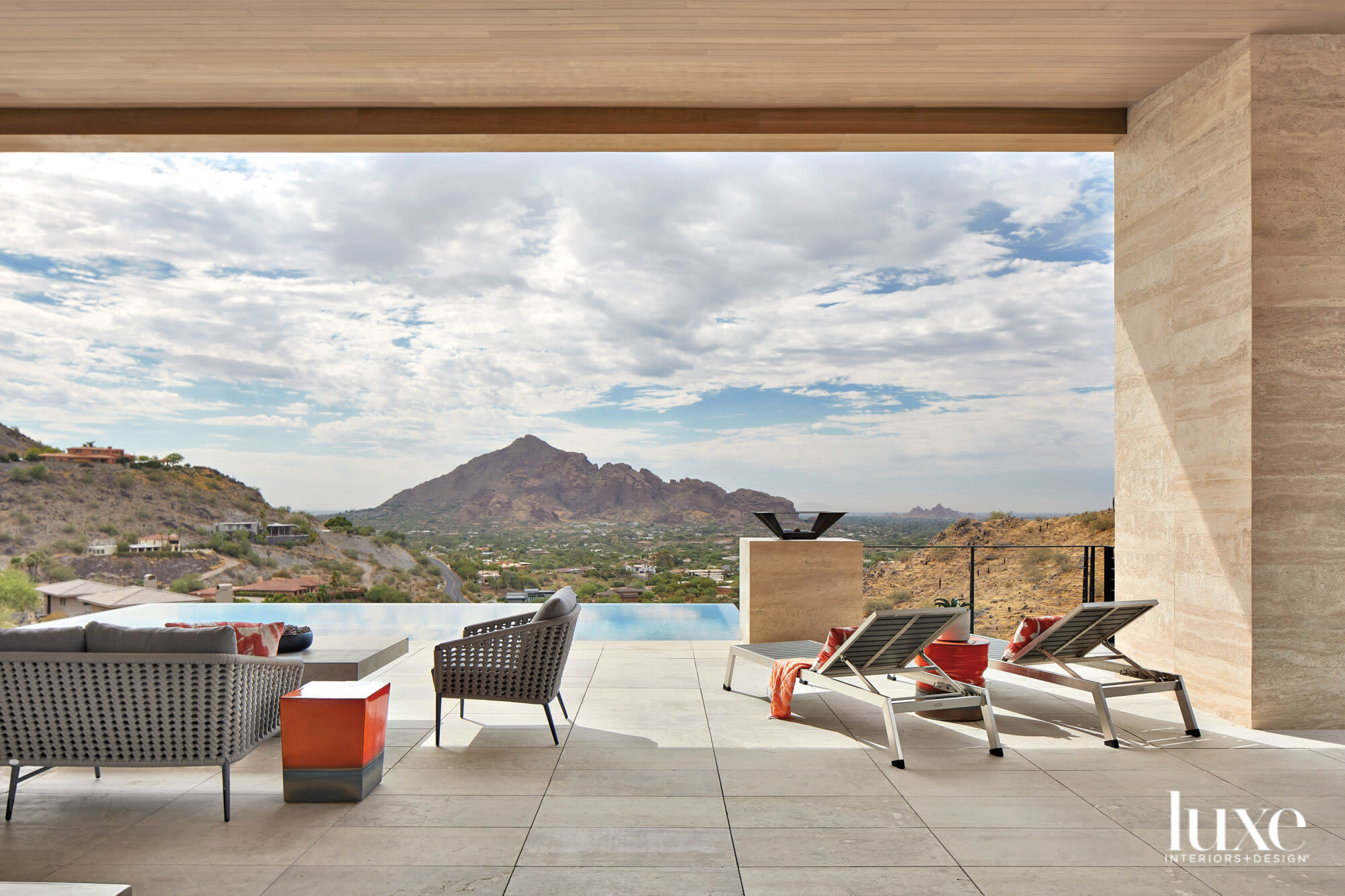 A poolside deck that looks out on the mountains.