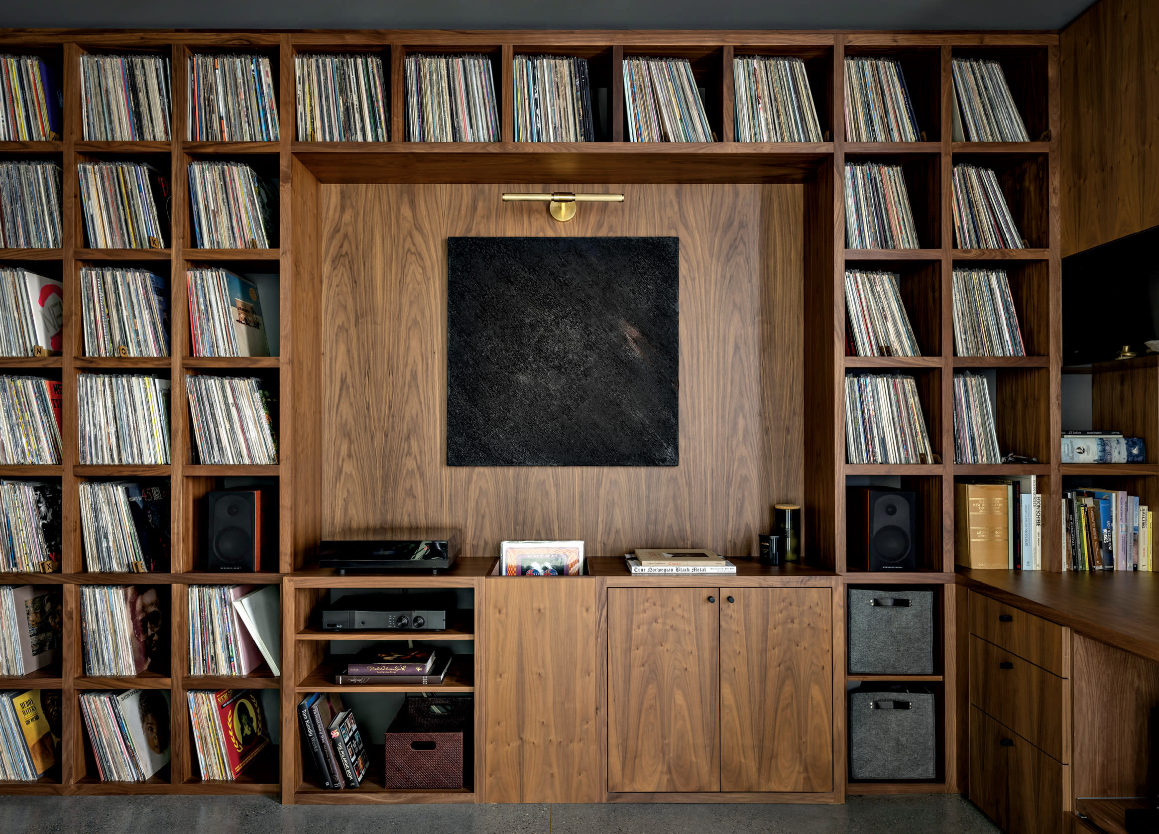 walnut shelves hold a vinyl record collection