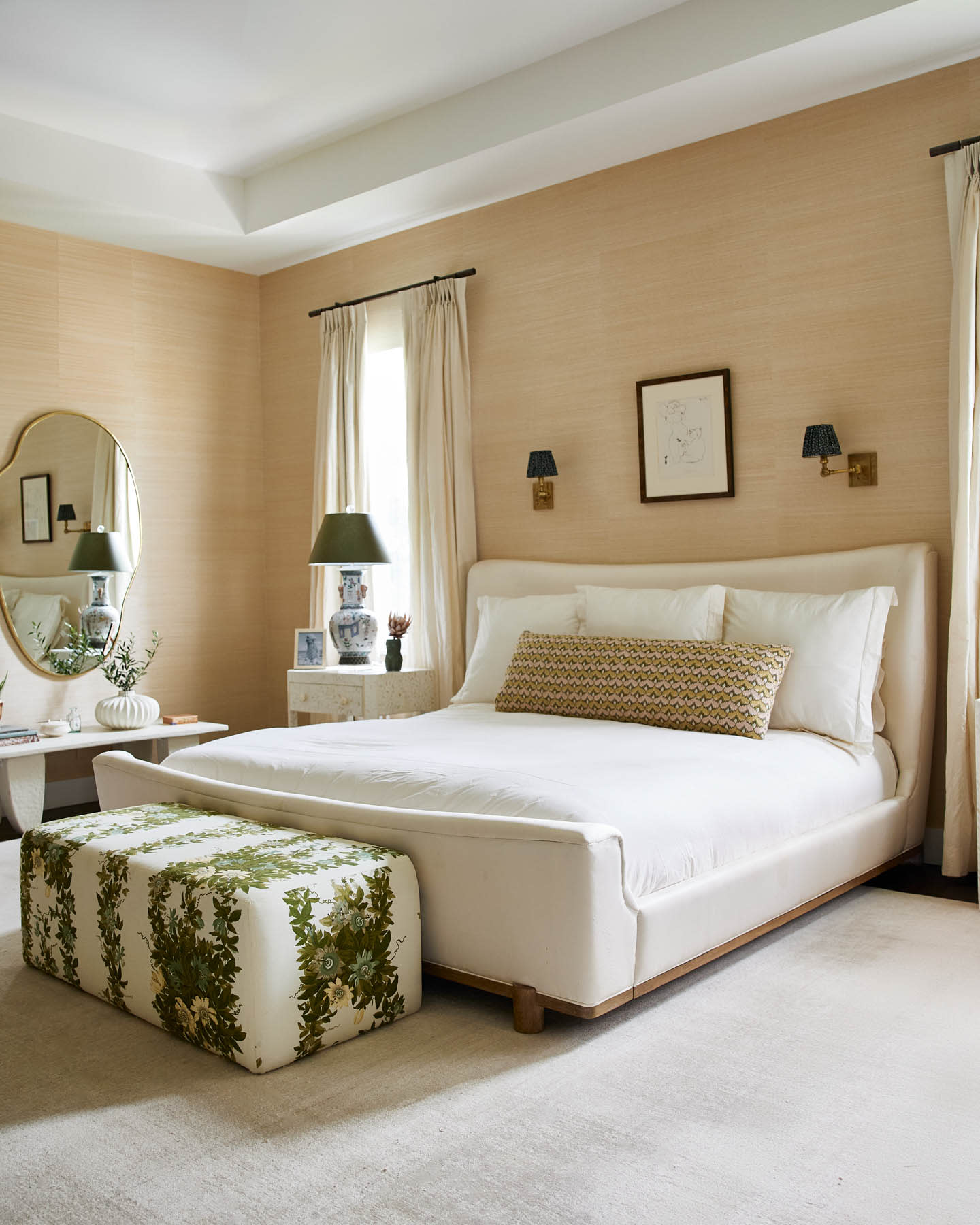 contemporary bedroom with a green and white bench at the foot of the bed and orange-beige walls