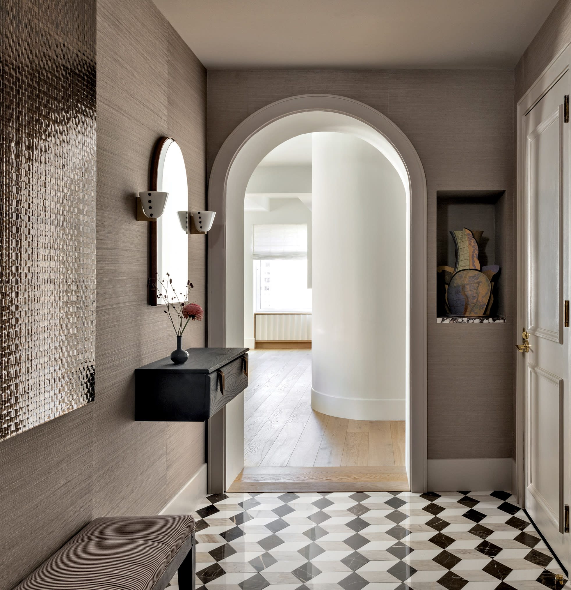 entryway with mosaic marble flooring and an arched doorway leading into the home