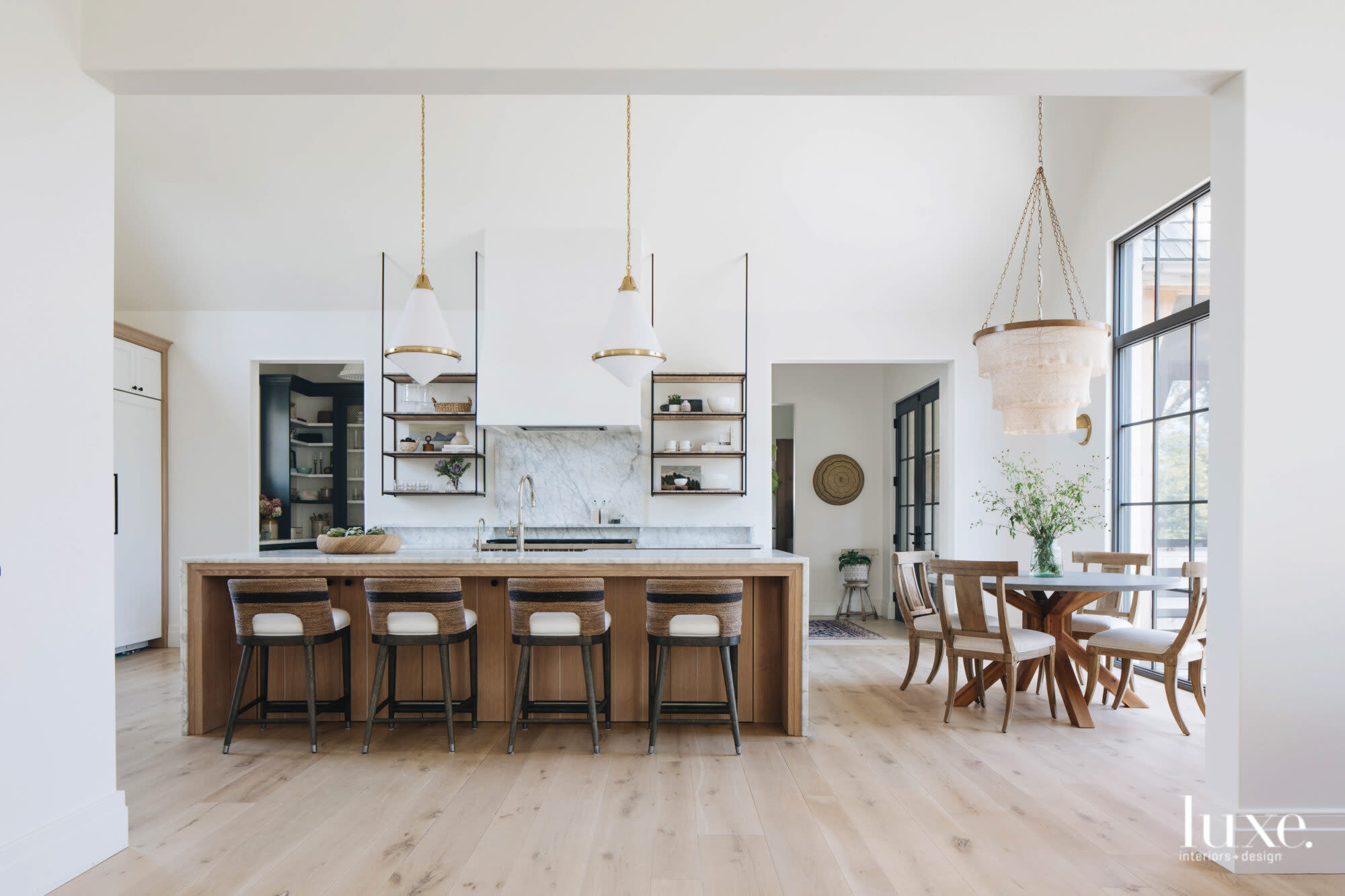 This huge yet simple kitchen is spotted with light wooden furnishings.