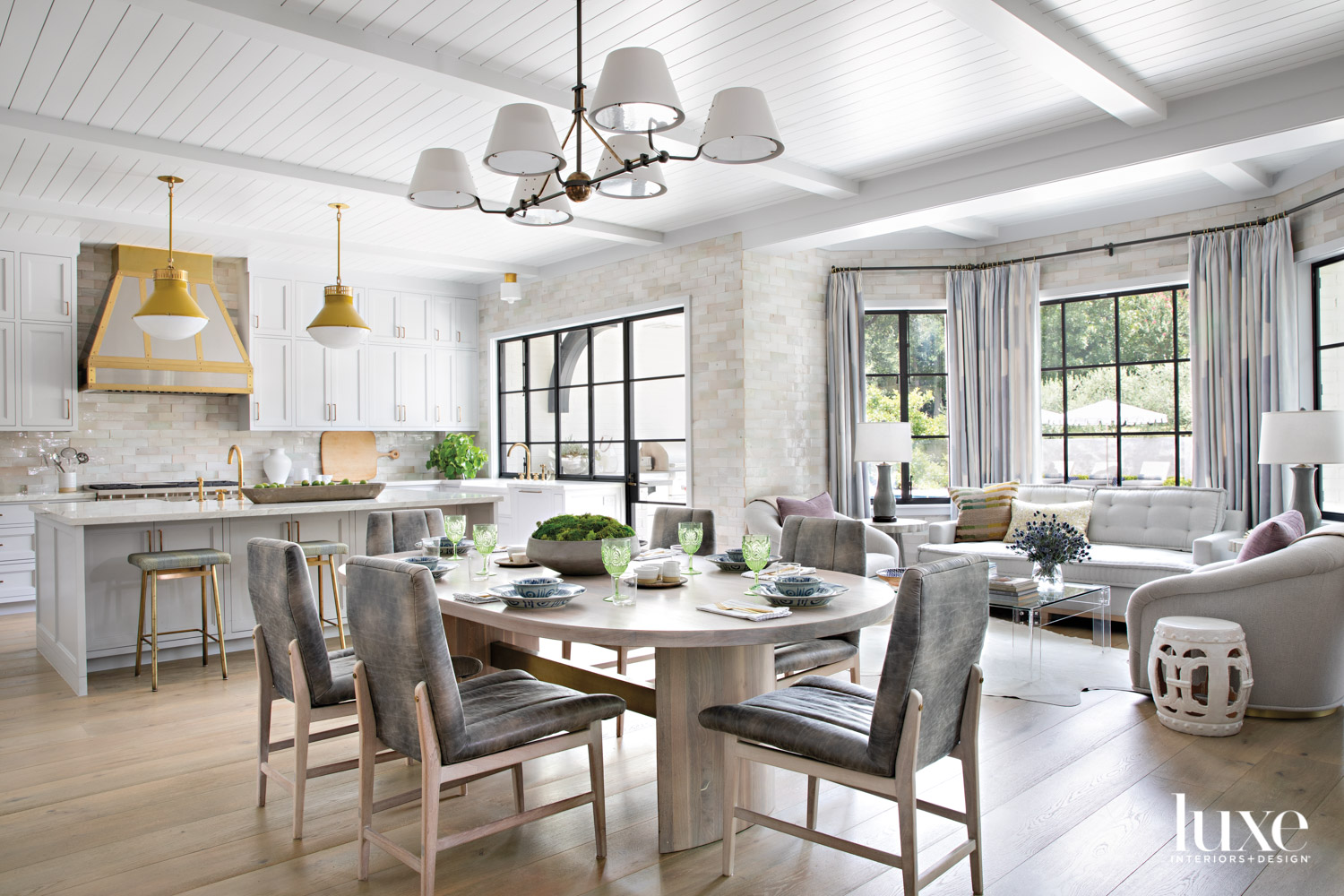 joined kitchen, dining and living space with tiled walls