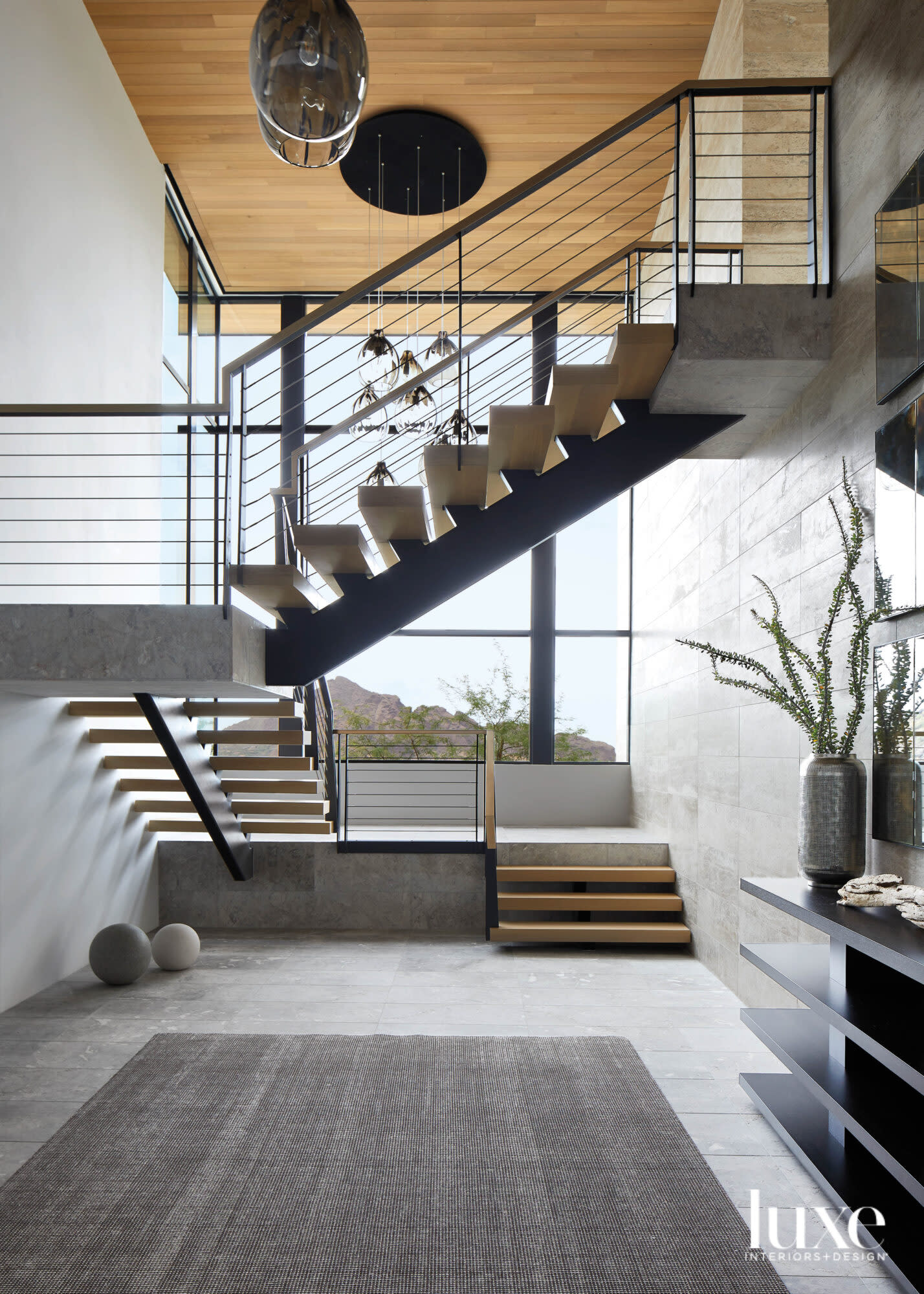 A modern staircase in a limestone room.