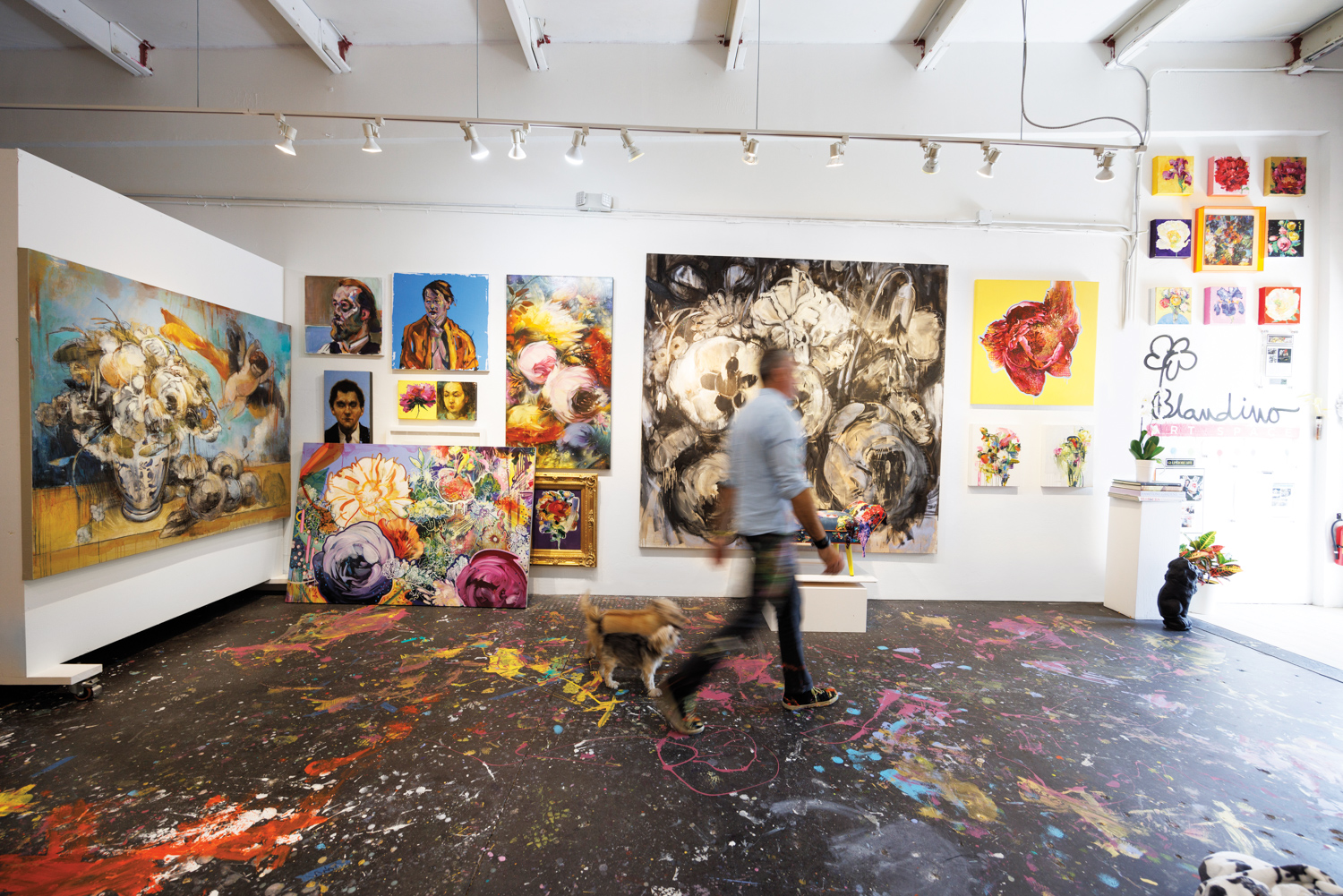 naples artist carmelo blandino walks in his studio with one of his dogs