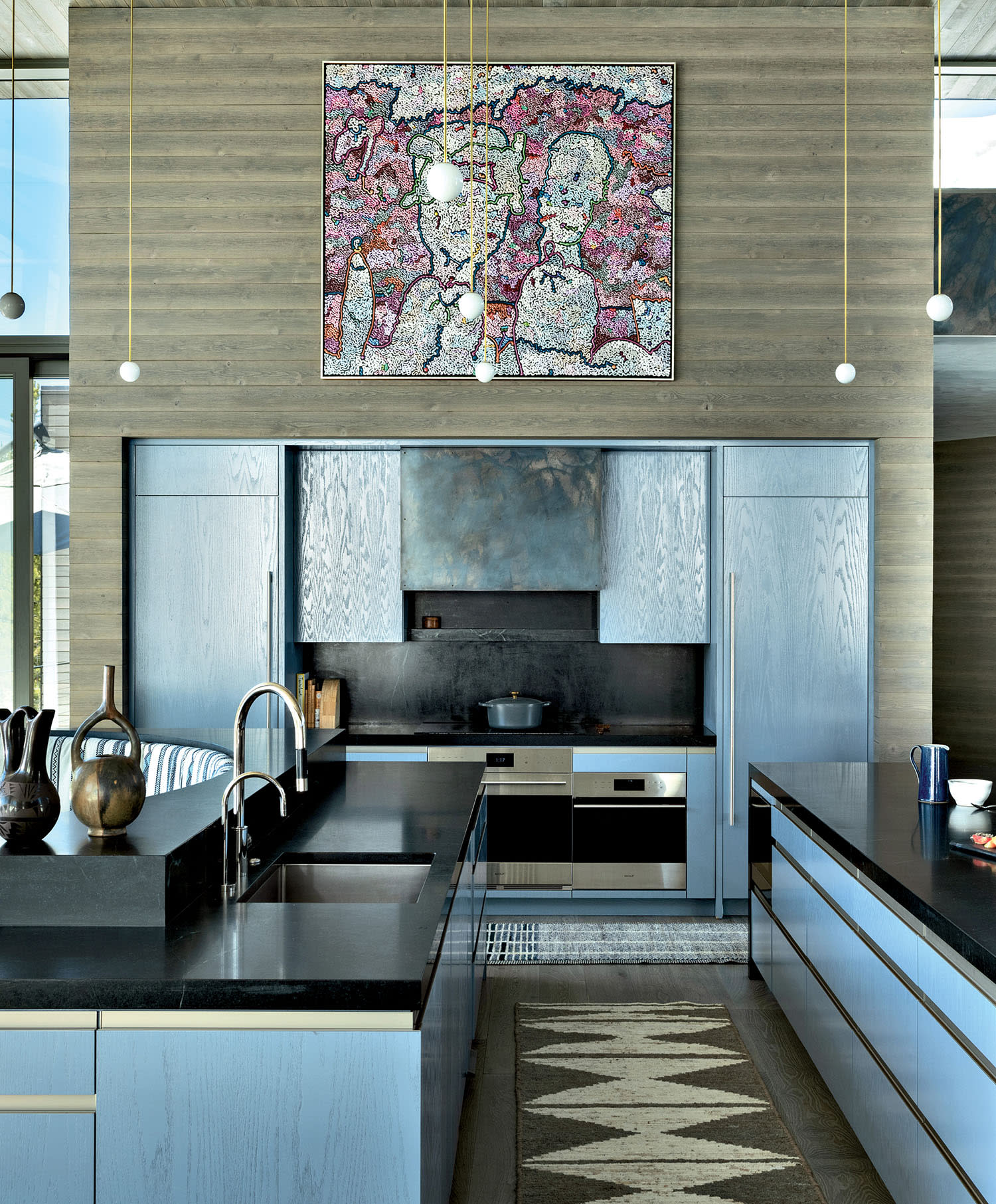 kitchen with black soapstone counters and red cedar cabinetry