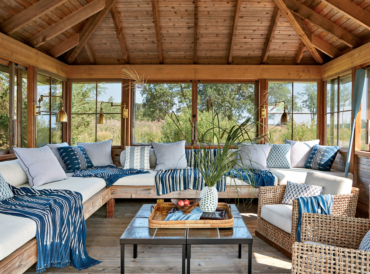 screened-in tea house with a sectional topped with blue pillows