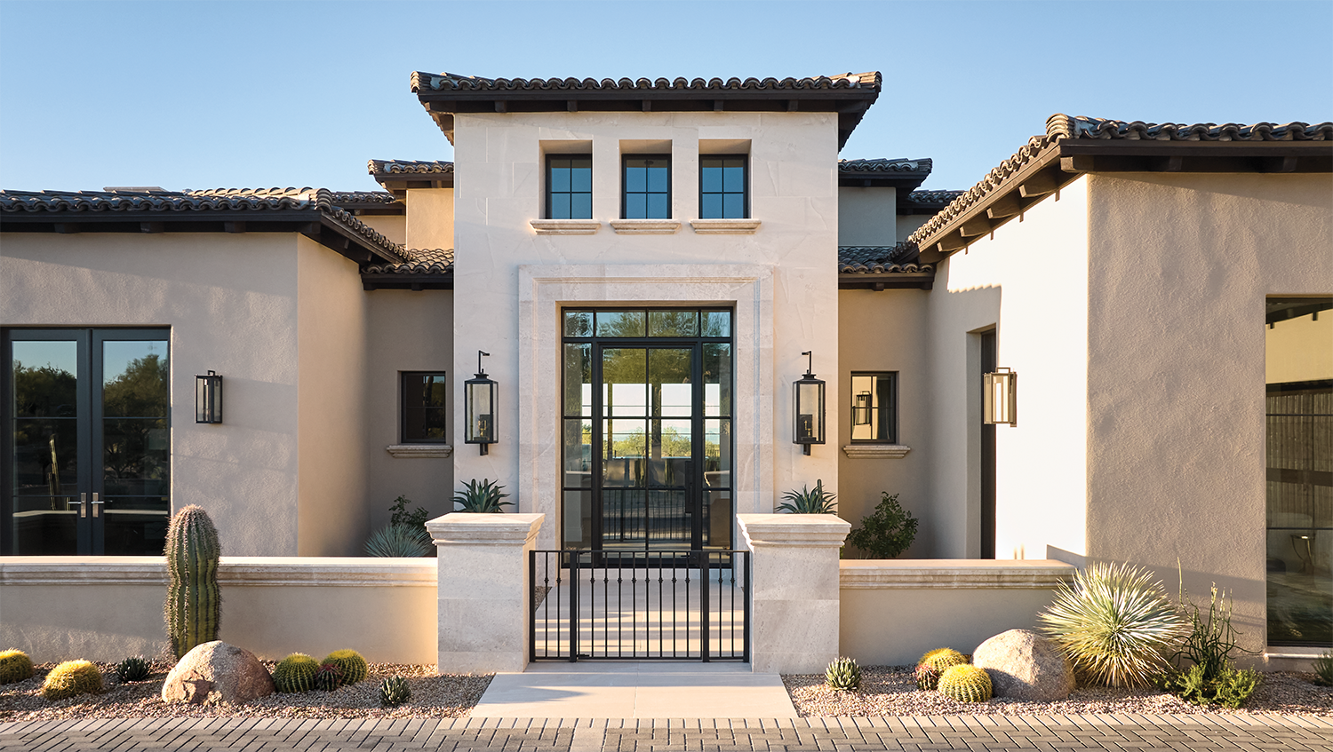 glass entry and Mediterranean-style facade of an Arizona home