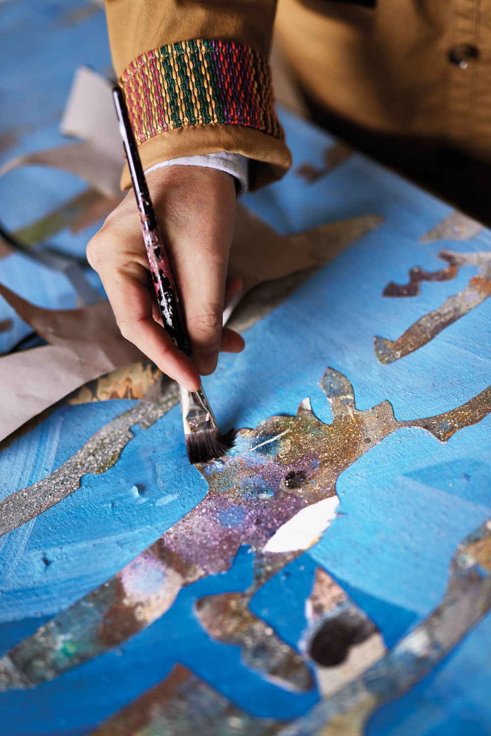A hand holding a paintbrush