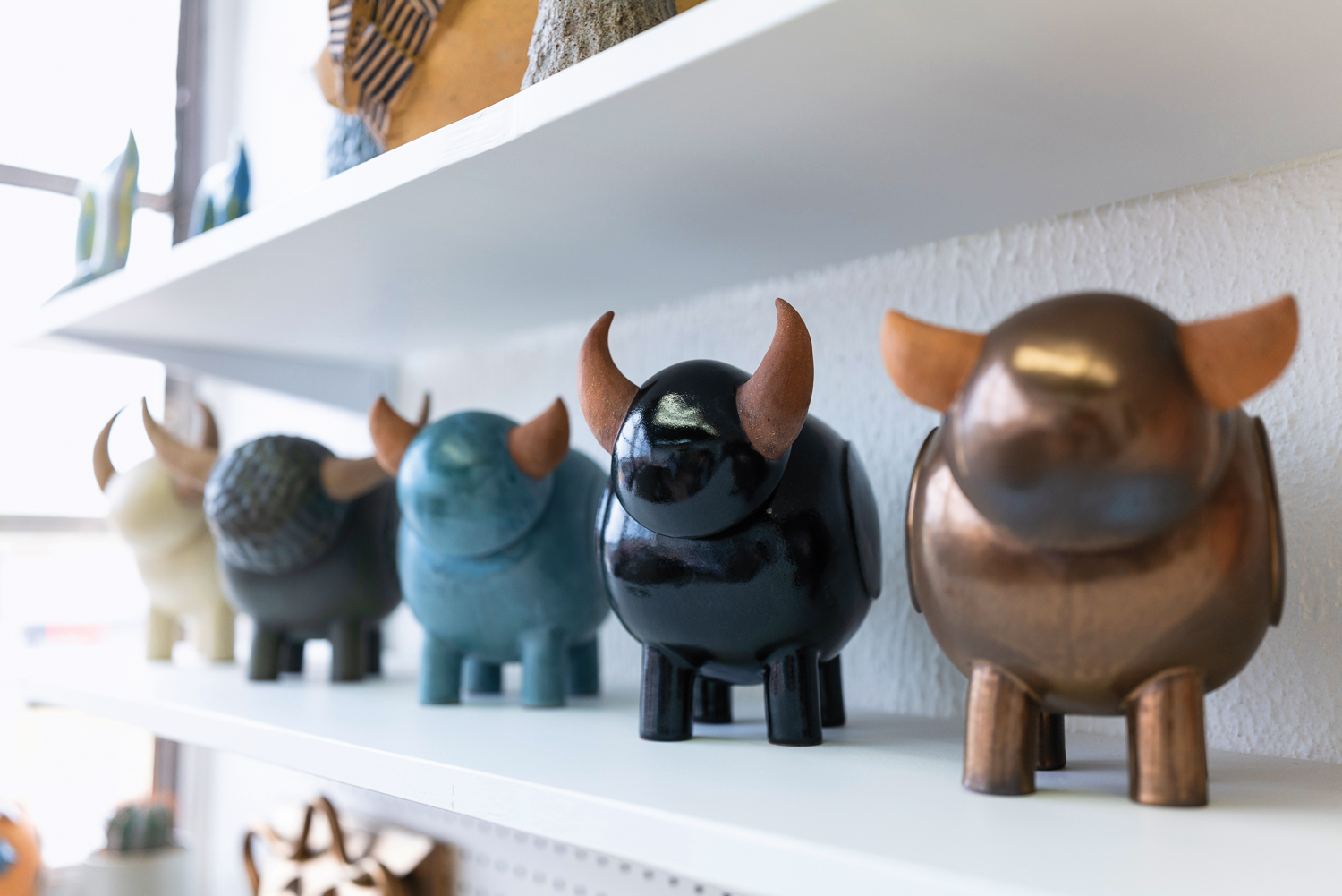 Shelves lined with glazed ceramic figures