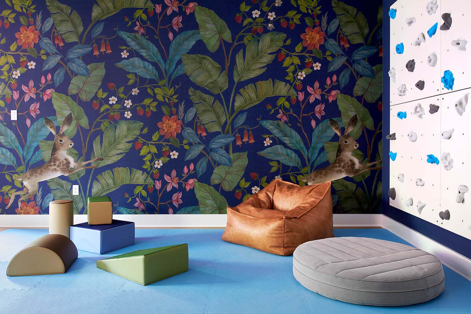 children's playroom with floral wallpaper and a climbing wall