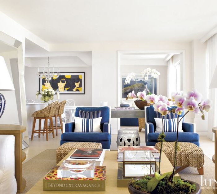 The great room—the home’s prime gathering spot—received big sofas and other comfy seating. The walls are covered in white grass cloth, while limestone flooring lends an added gentle beachy touch throughout.