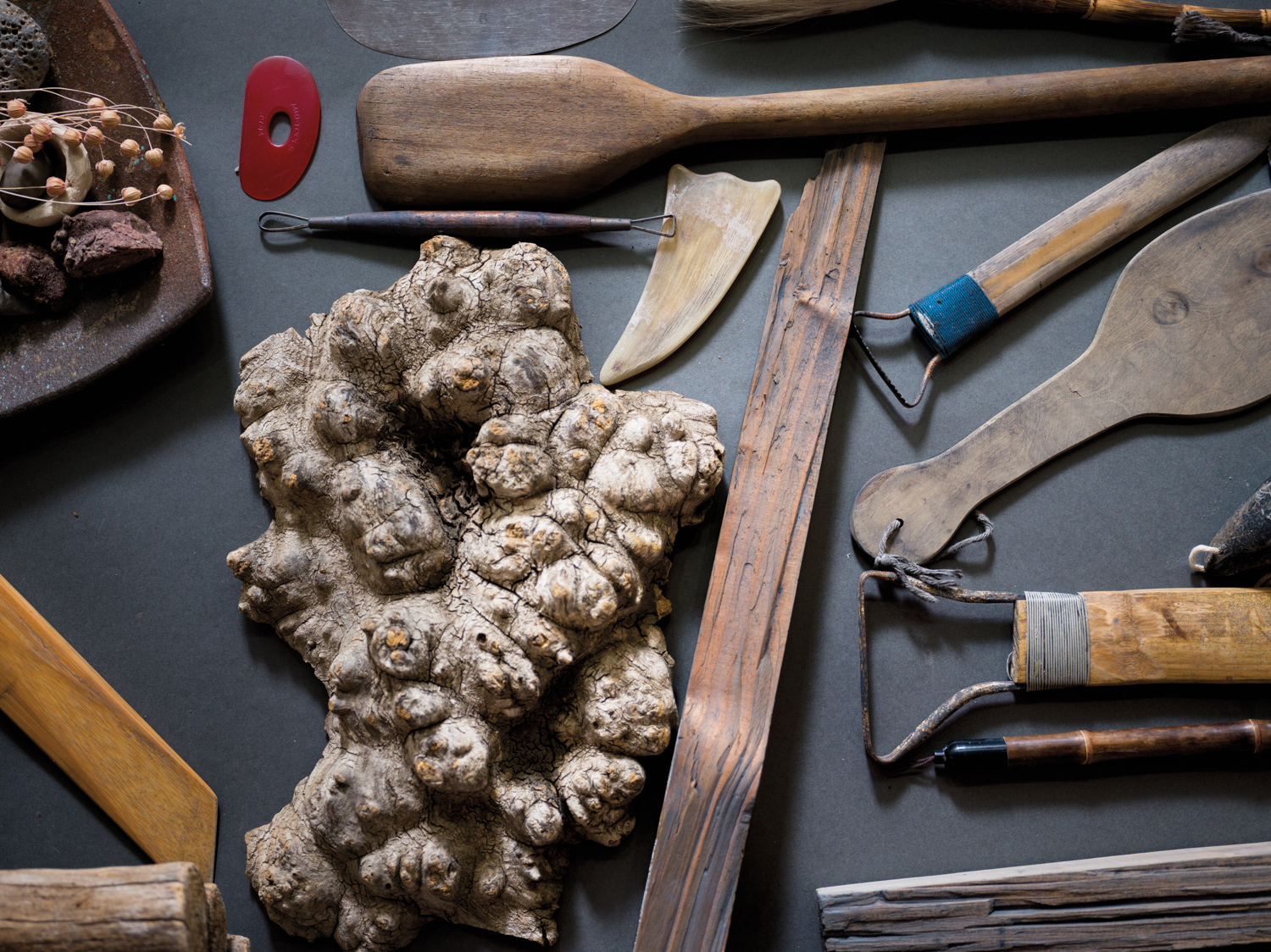 Sculpting tools next to an organic-looking clay piece
