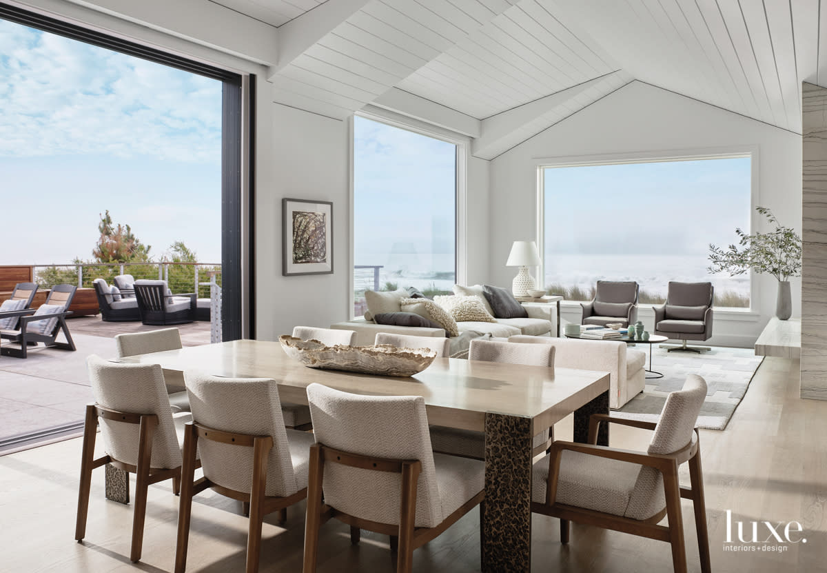 A sand and driftwood inspired dining room with views to the water.