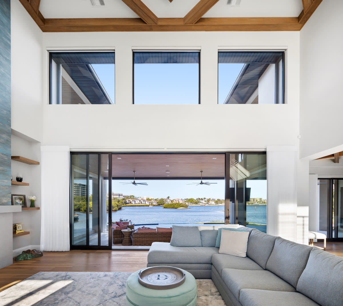 A serene living room with a couch and a scenic water view.