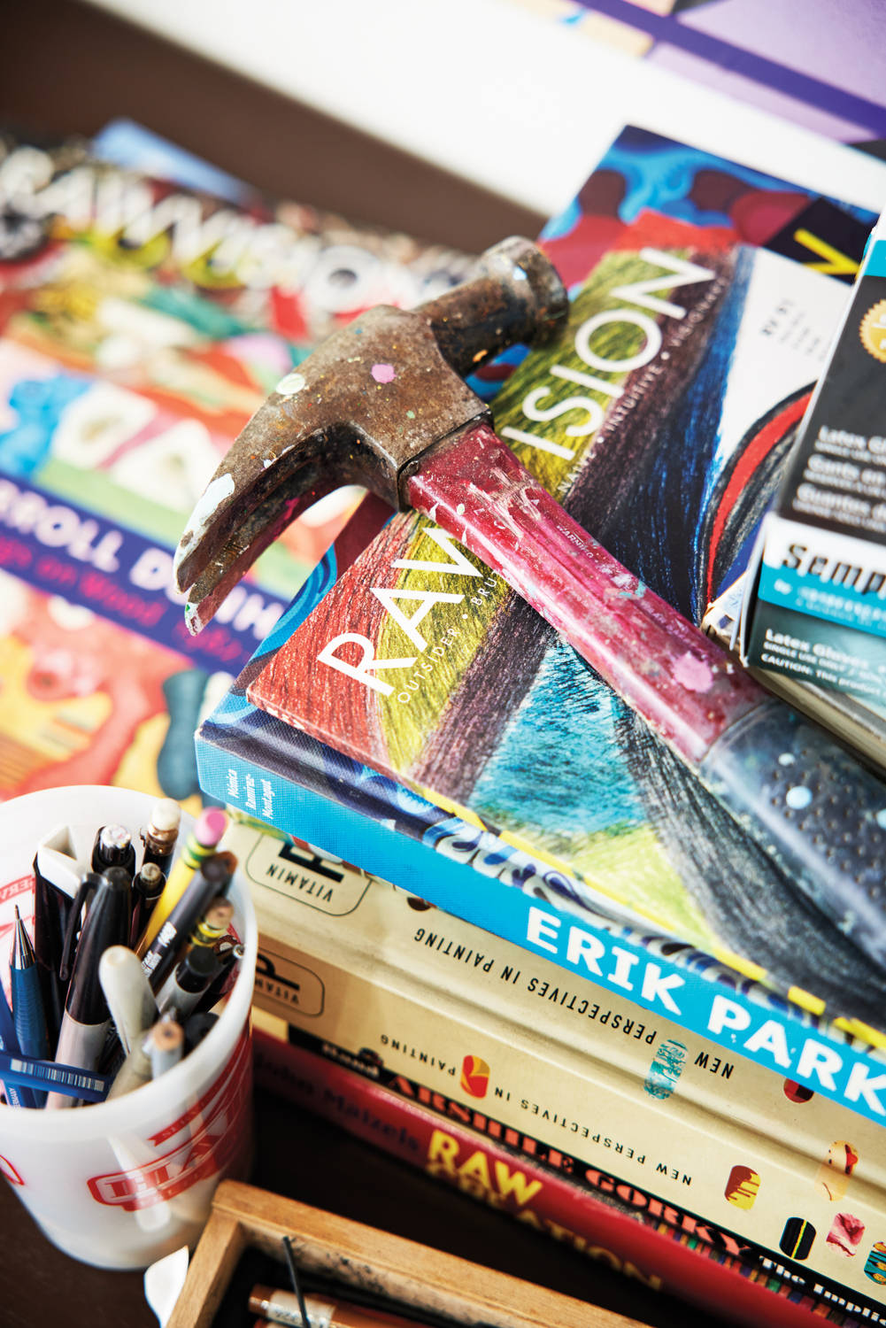 A pile of books with a hammer on top.