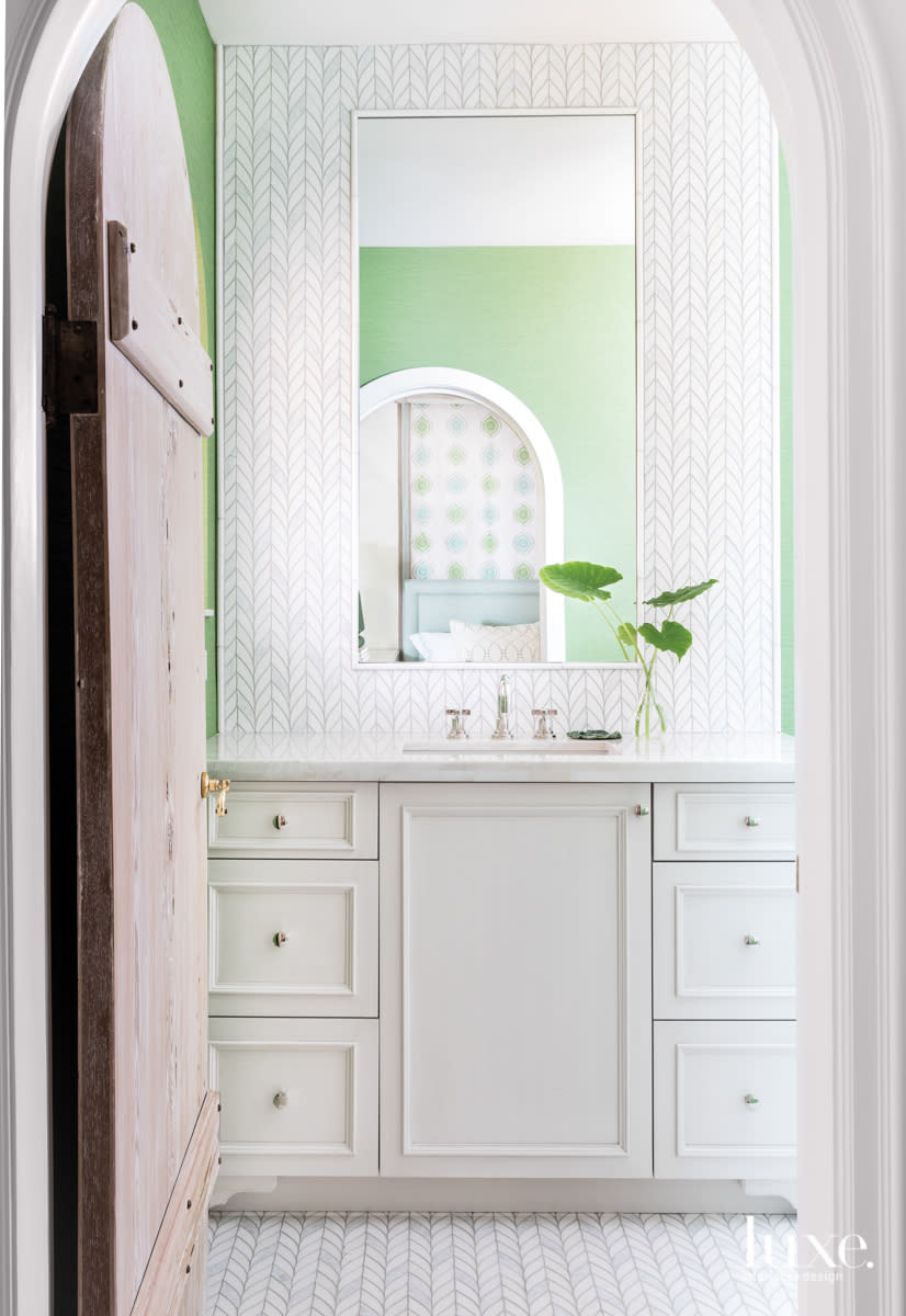 bathroom with green walls, white tile and white countertop