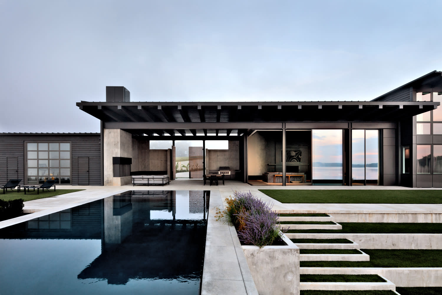 modern lakeside home with a pool