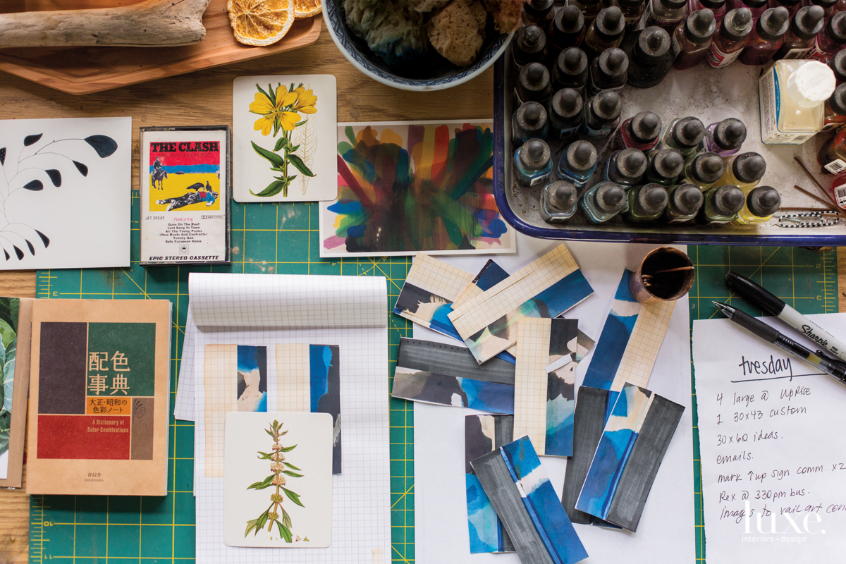 To use as a reference point throughout the multi-step dye process, the artist creates color samples on pieces of paper.