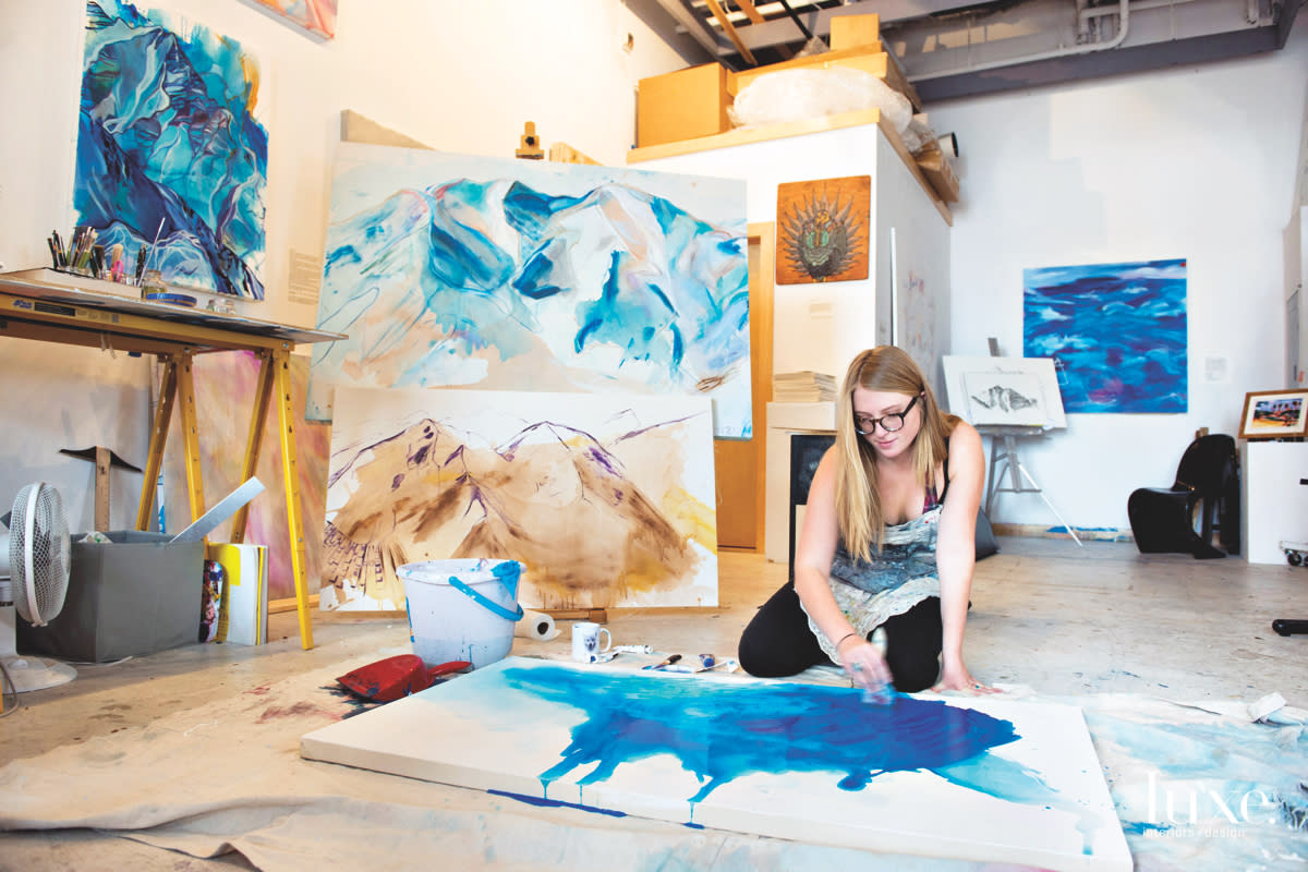 Artist Kelly Peters begins most of her works on the floor to mix the paint and allow it to dry.