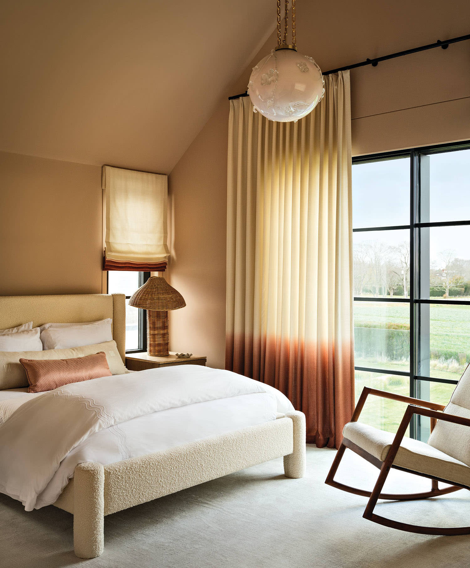 peach-tone guest befroom with ombre orange and red curtains
