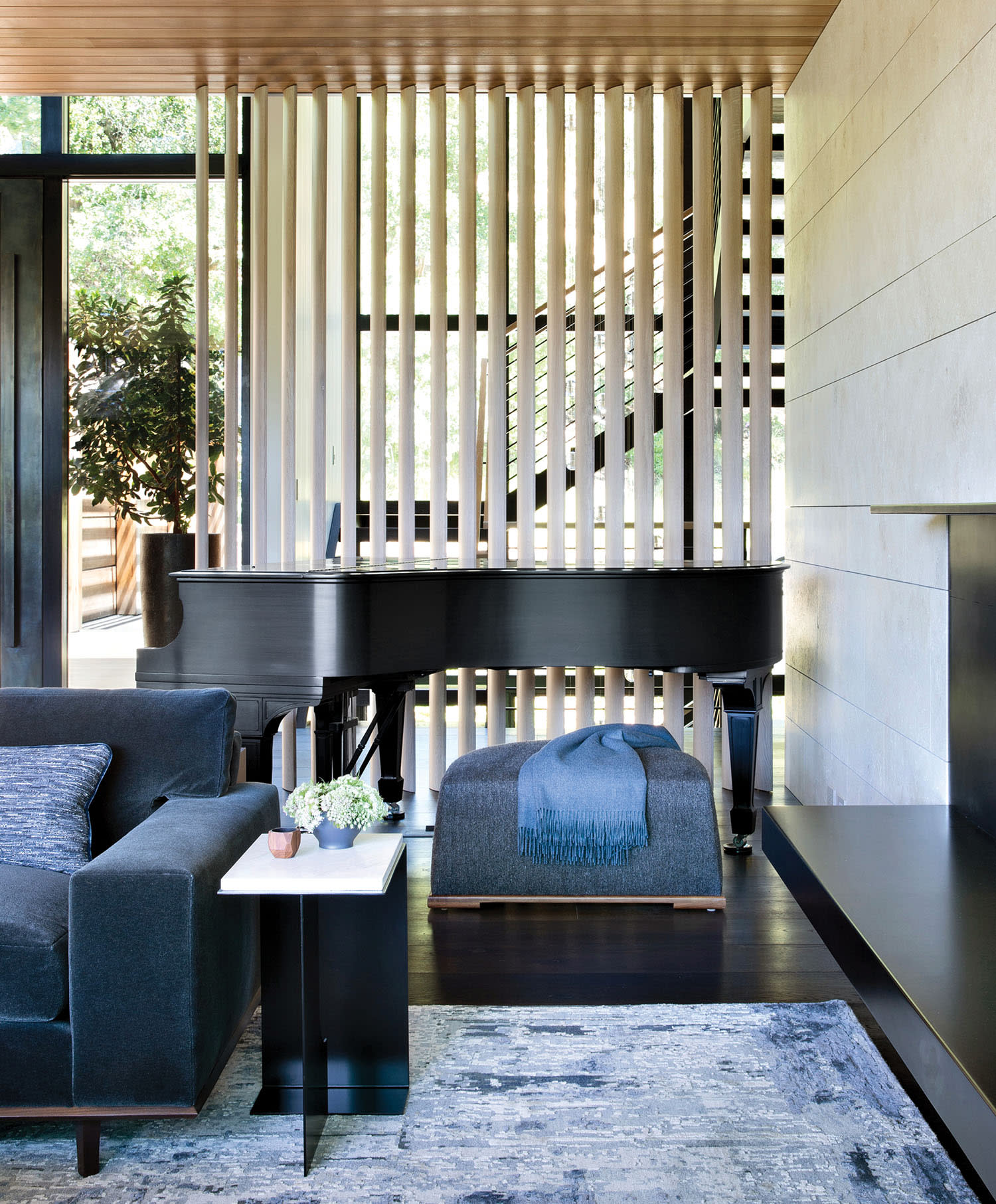 contemporary living room with an oak-slatted screen partition
