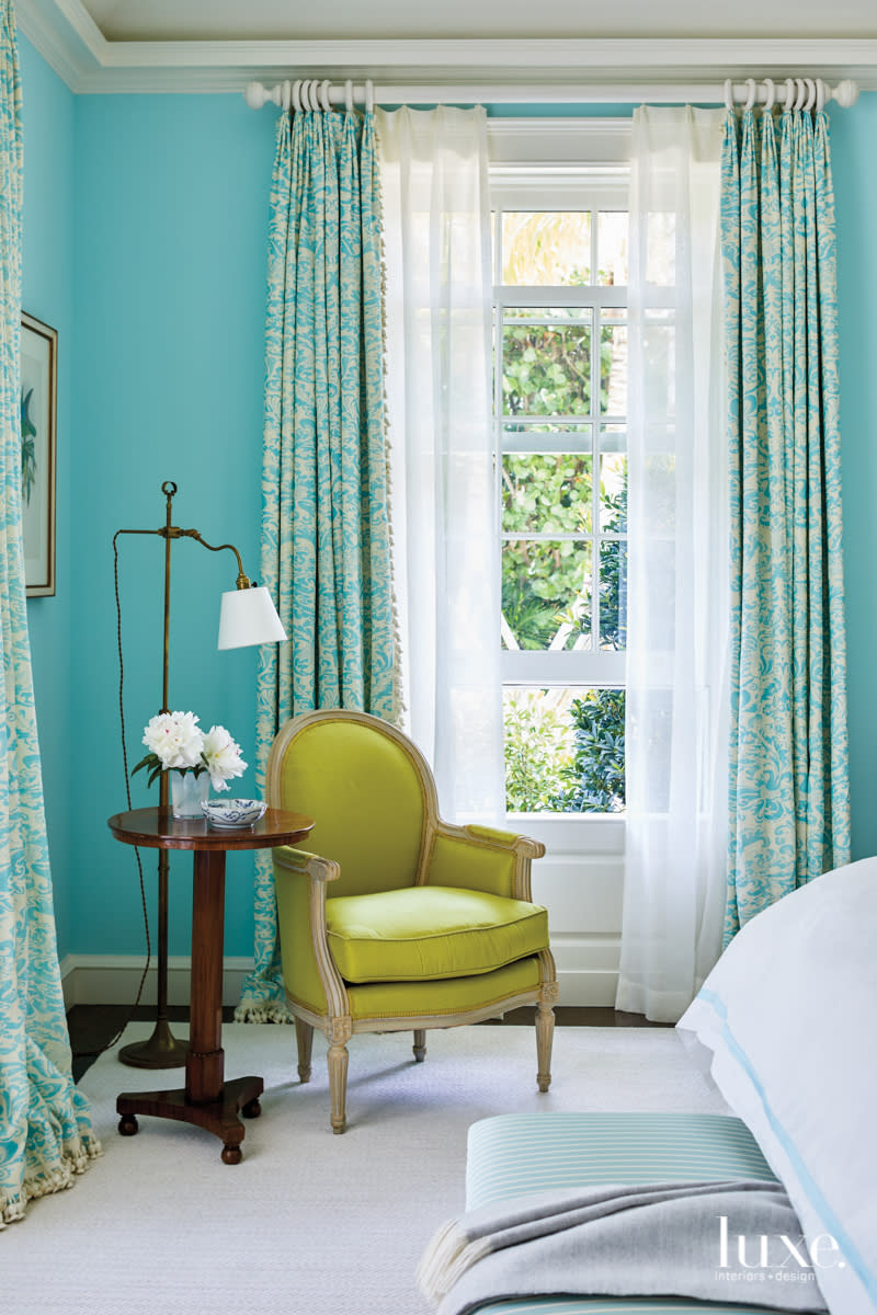 green armchair in aqua bedroom