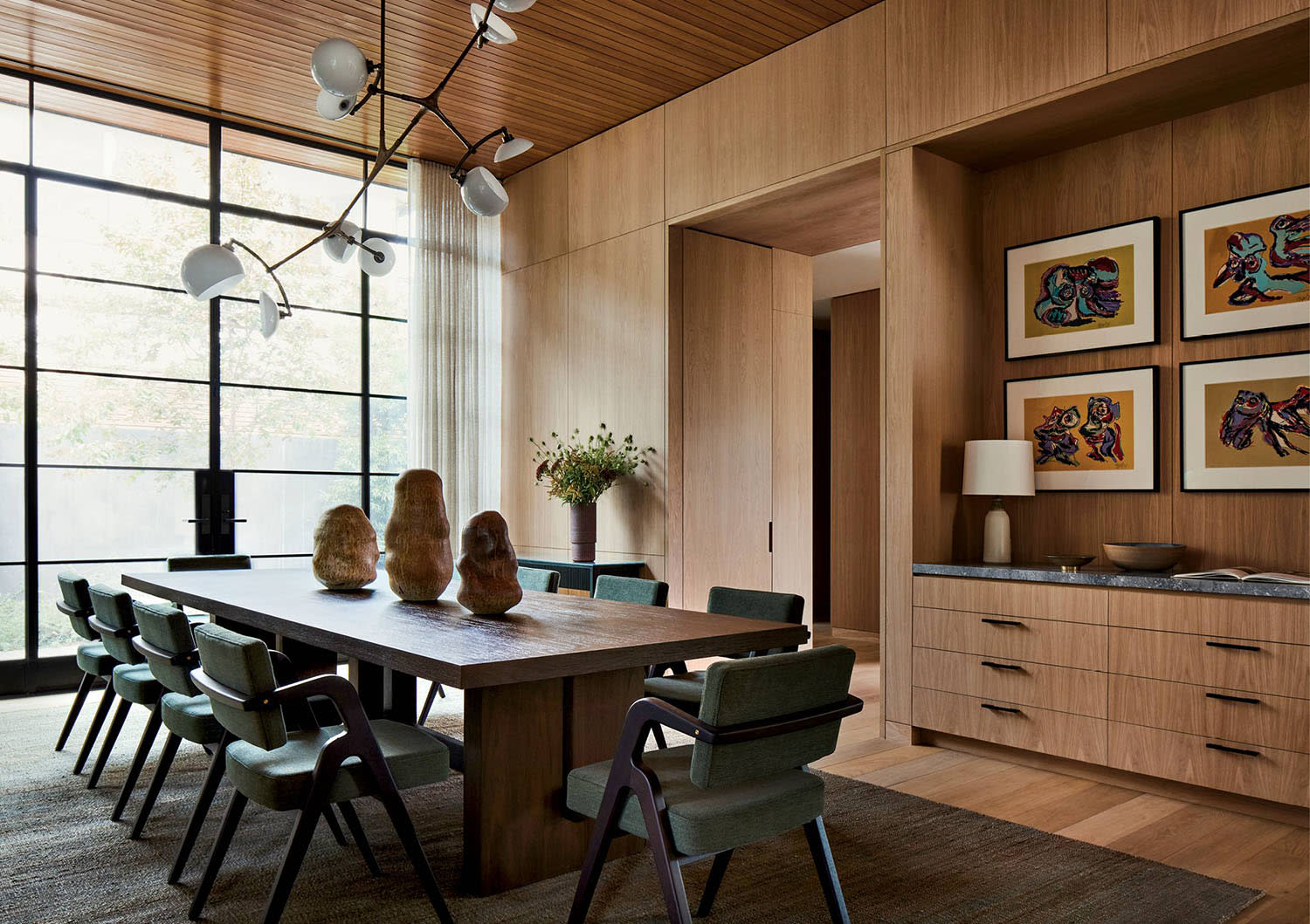 oak-clad dining room with a large family-style dining table 