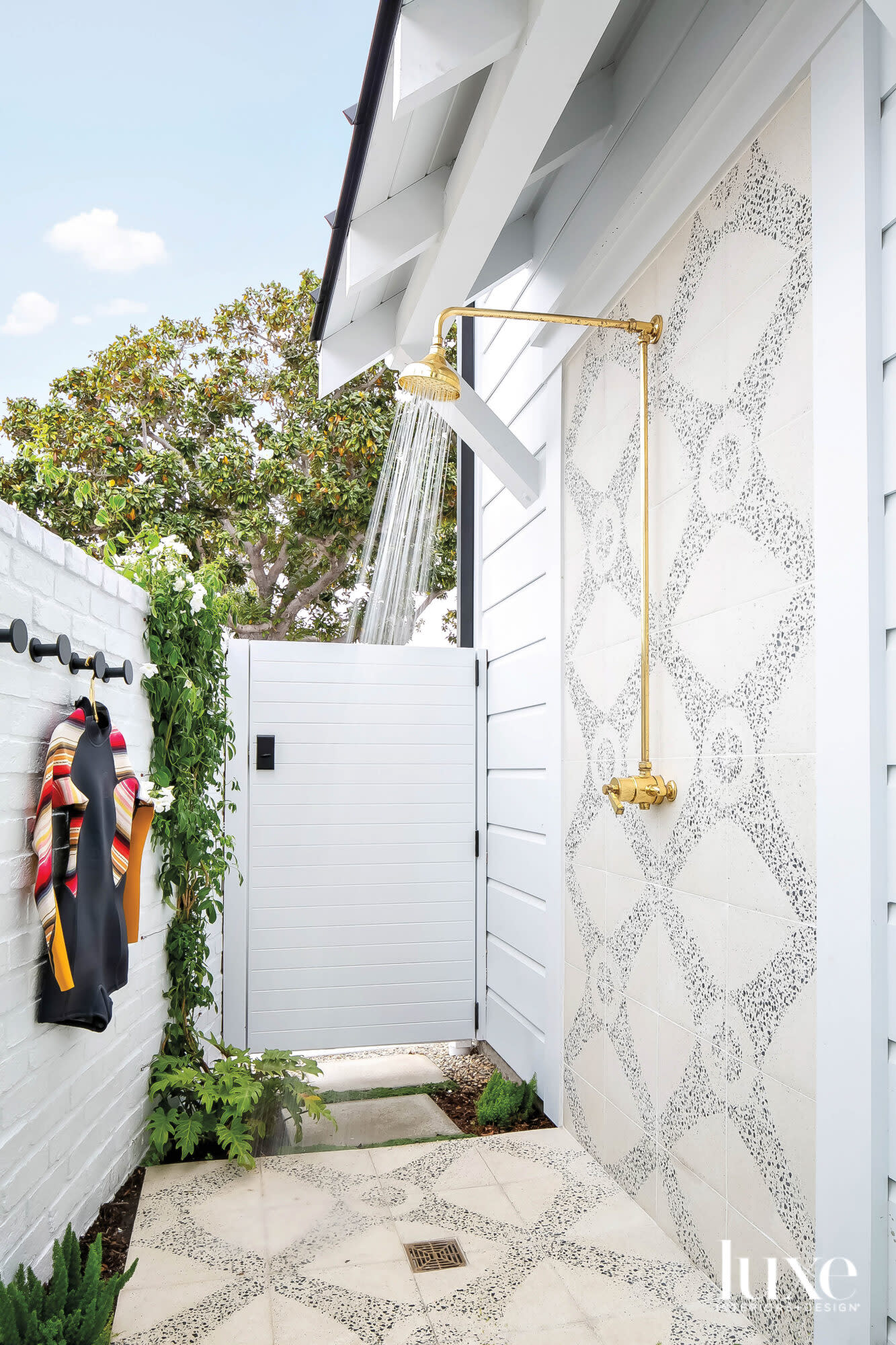 Outdoor shower with pebble-tile accent wall