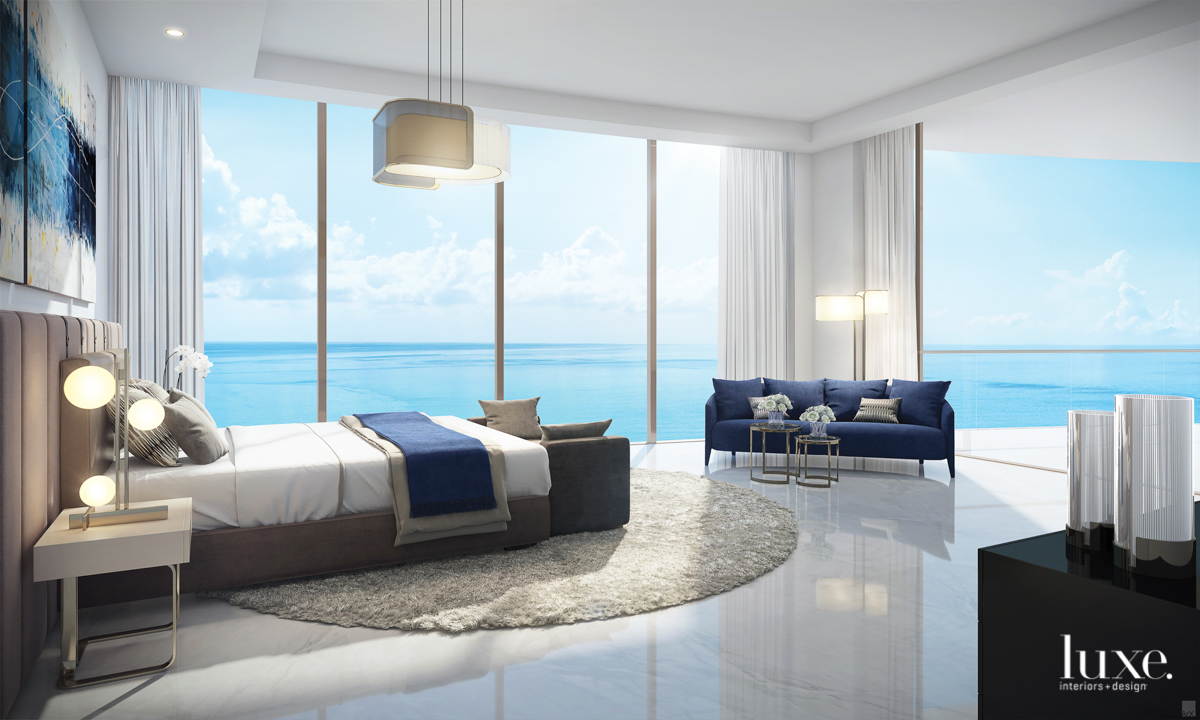 view of the ocean from bedroom with bed and couch