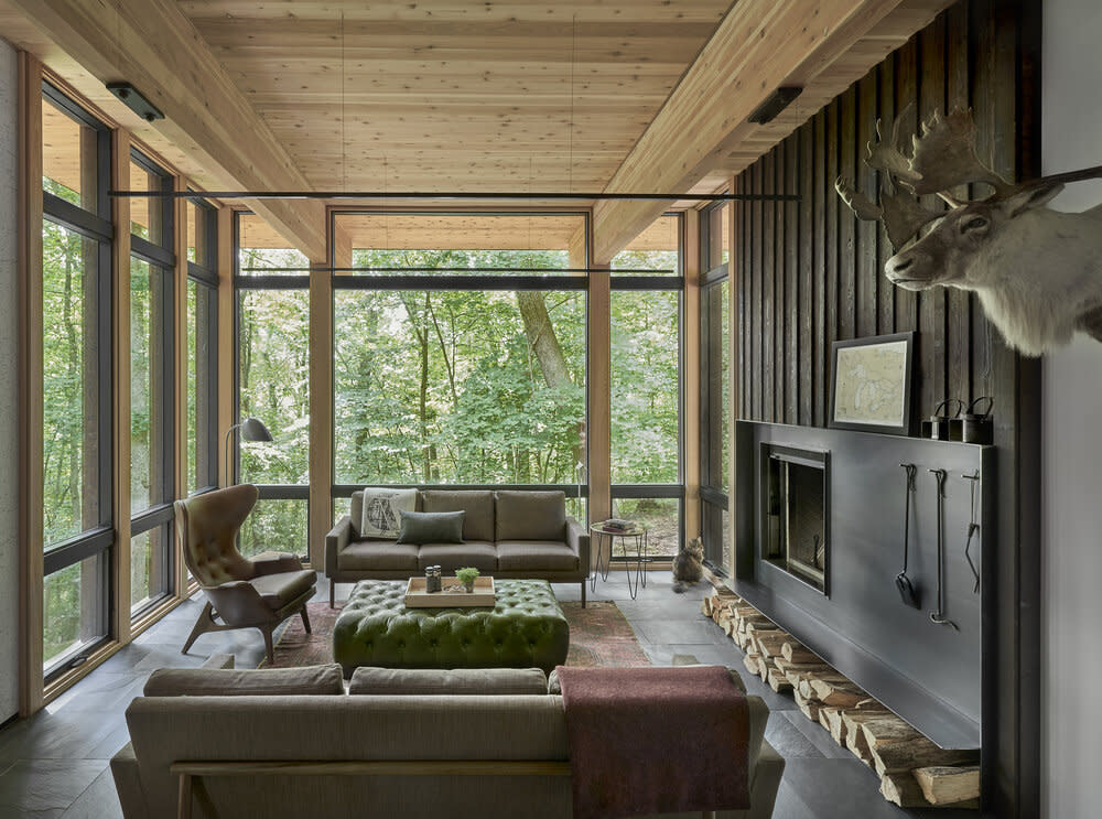 Cozy den with wood ceiling, fireplace and floor to ceiling windows