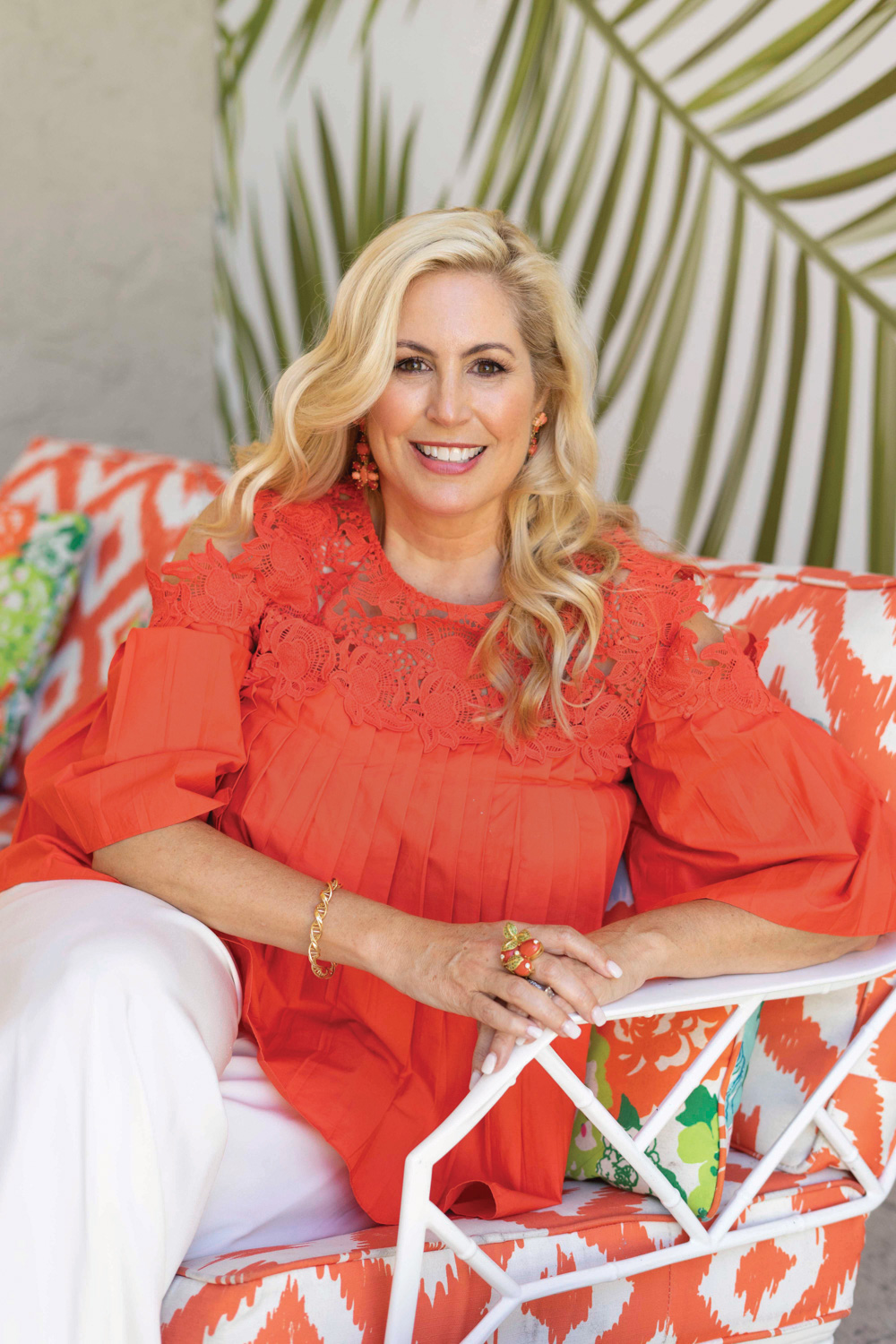 Portrait of designer Carla Fonts Hrncir in a bright orange top