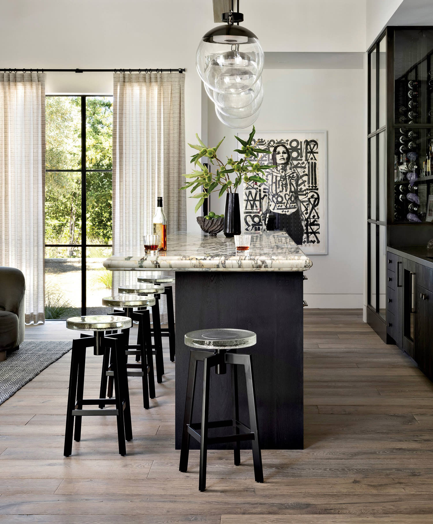 contemporary island with glass and metal stools