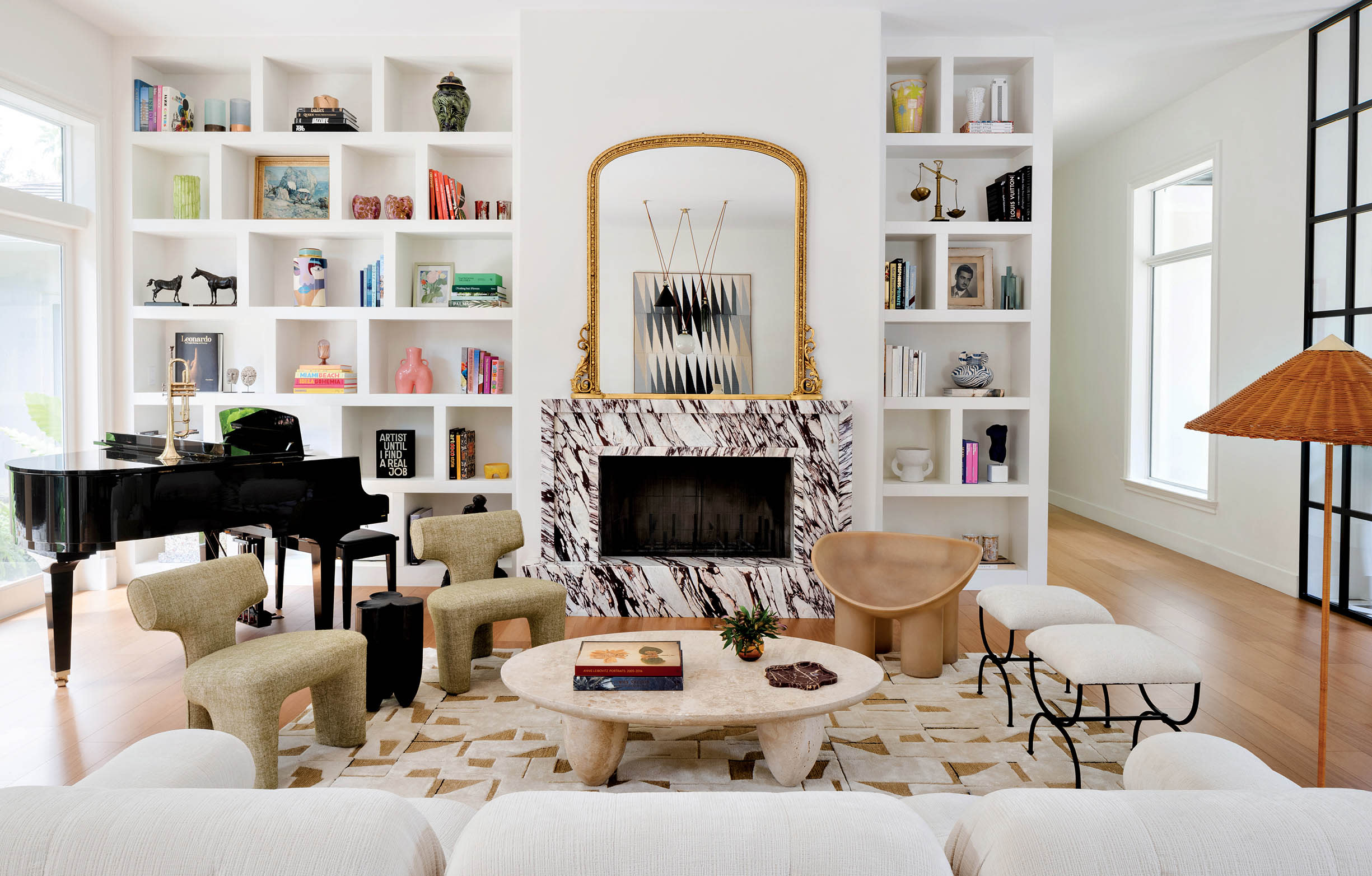 bright living room with modern furnishings and a black marbled fireplace