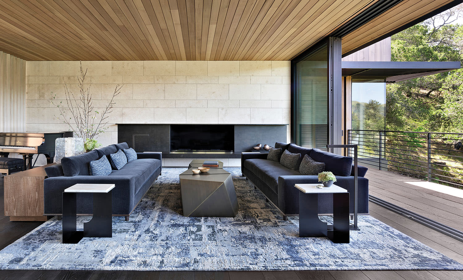 contemporary neutral living room with a wood slat ceiling and a fireplace