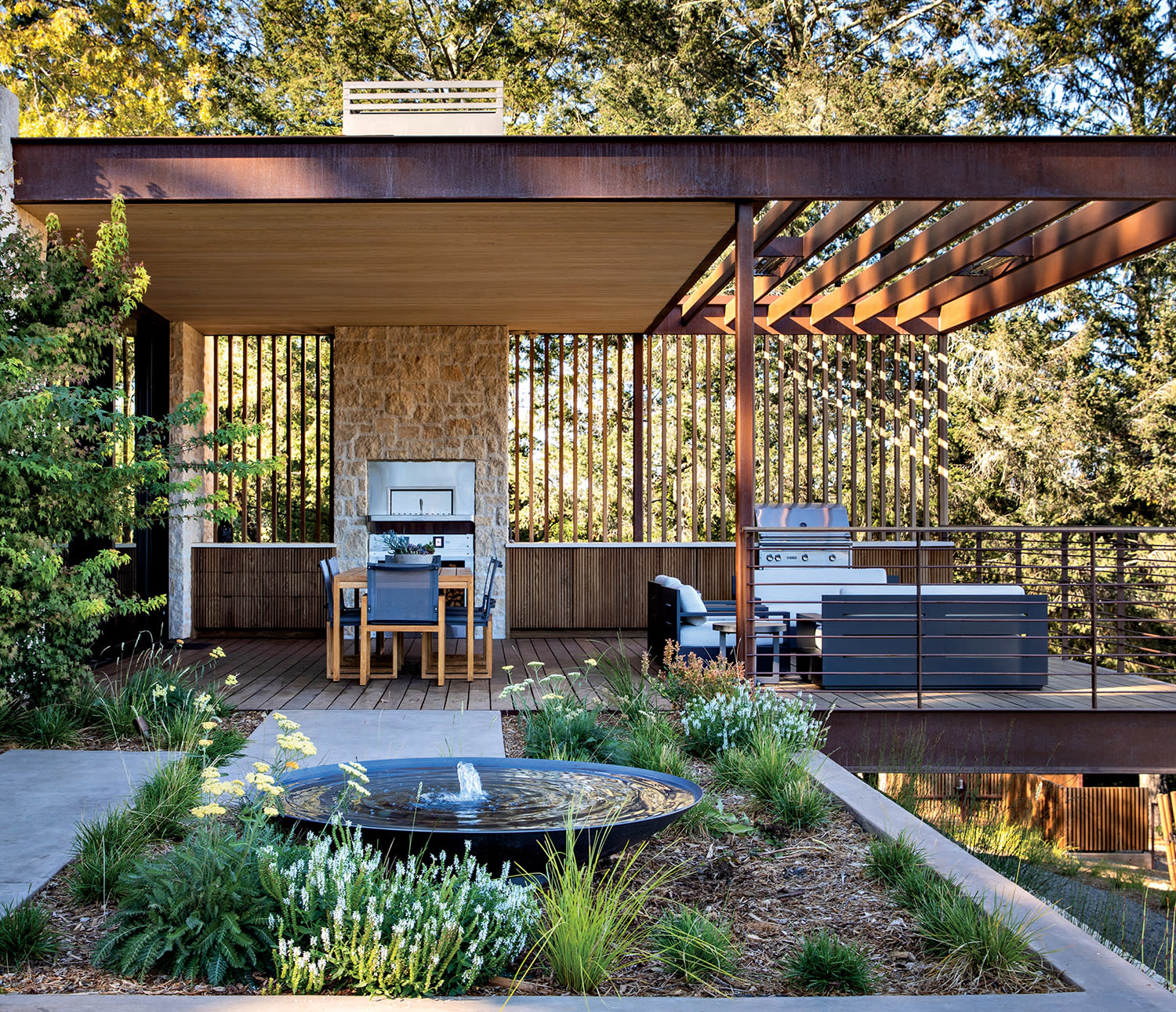 modern outdoor dining area surrounded by trees