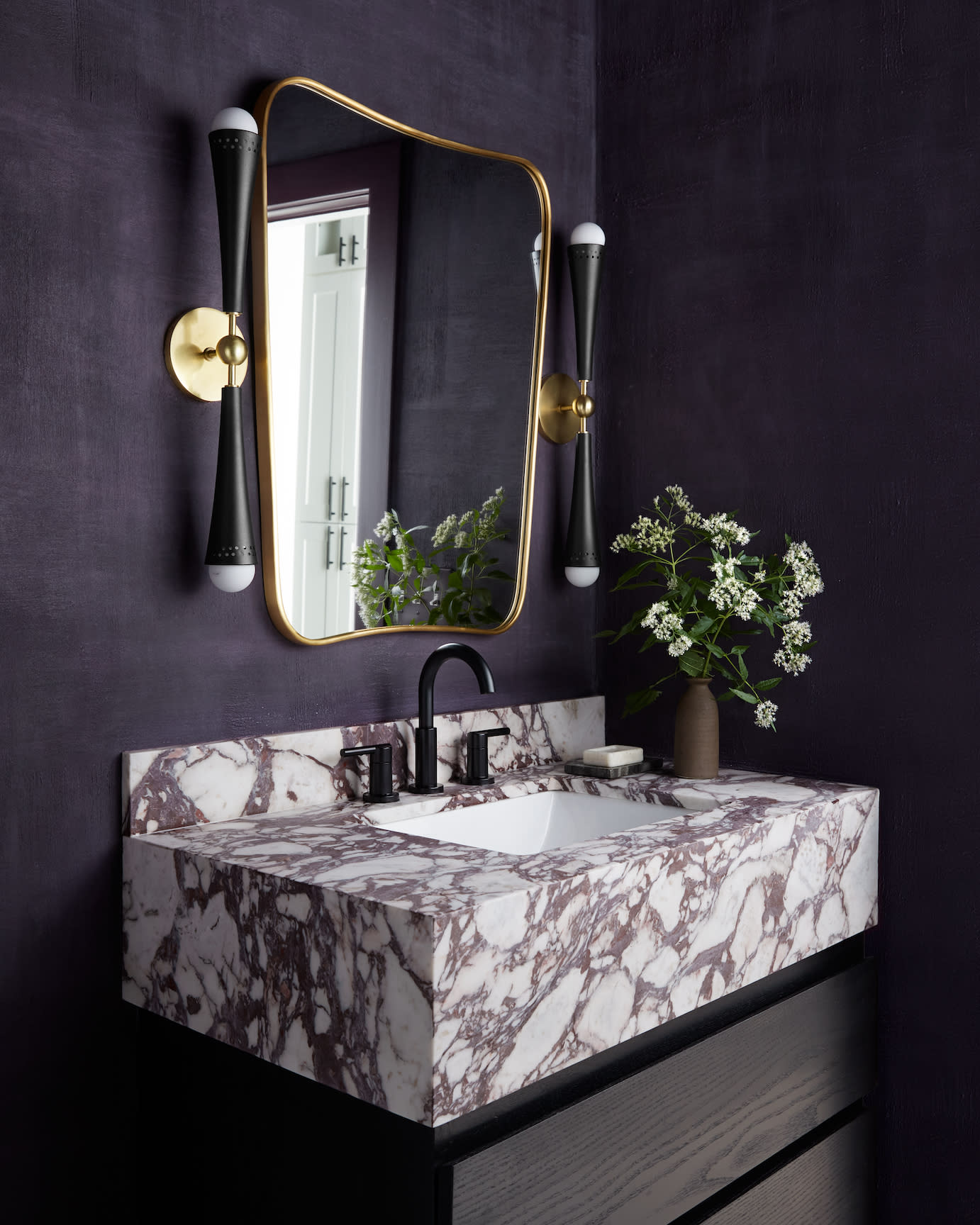 powder room with dark purple walls and calacatta viola marble