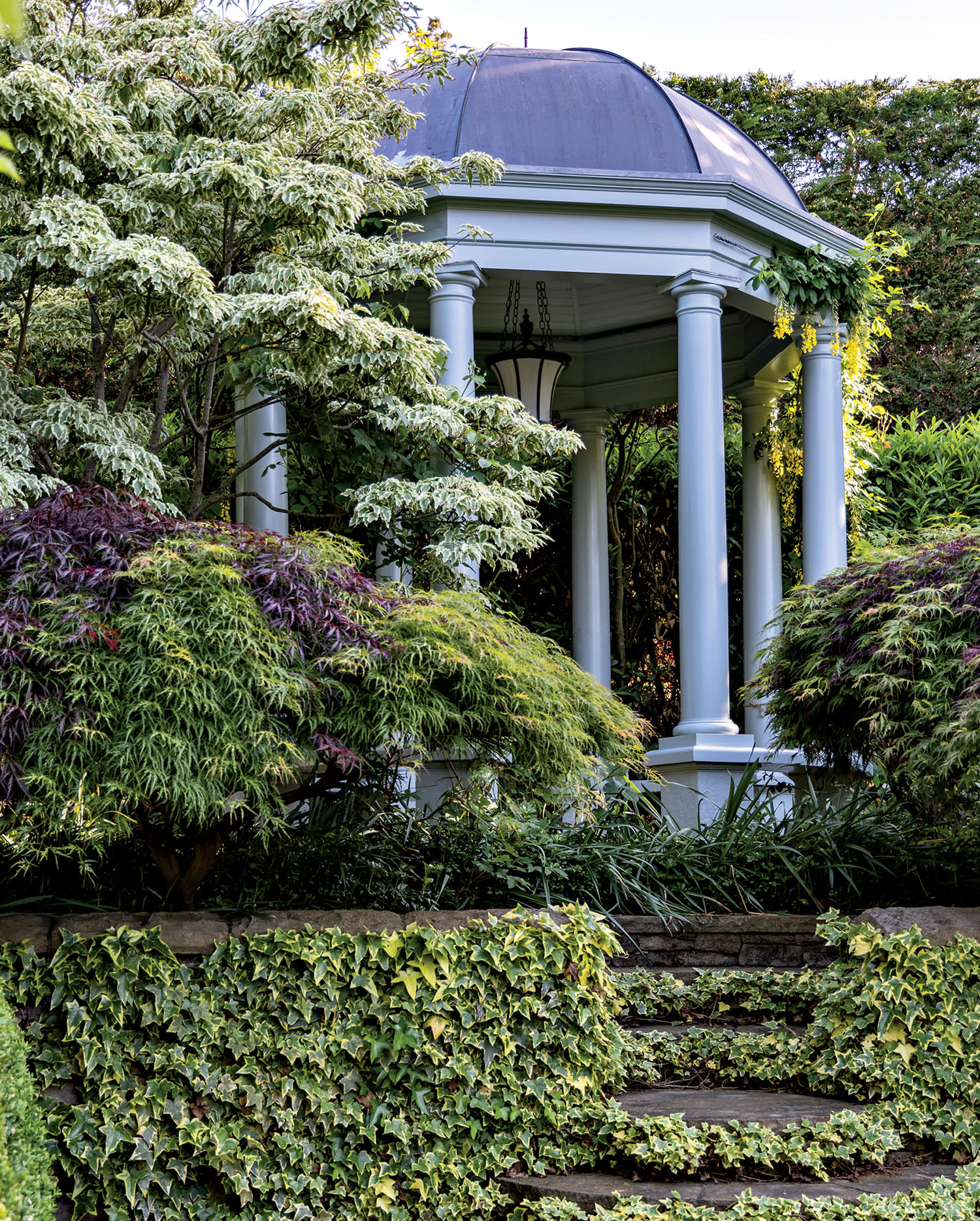 gazebo surrounded by lush gardens