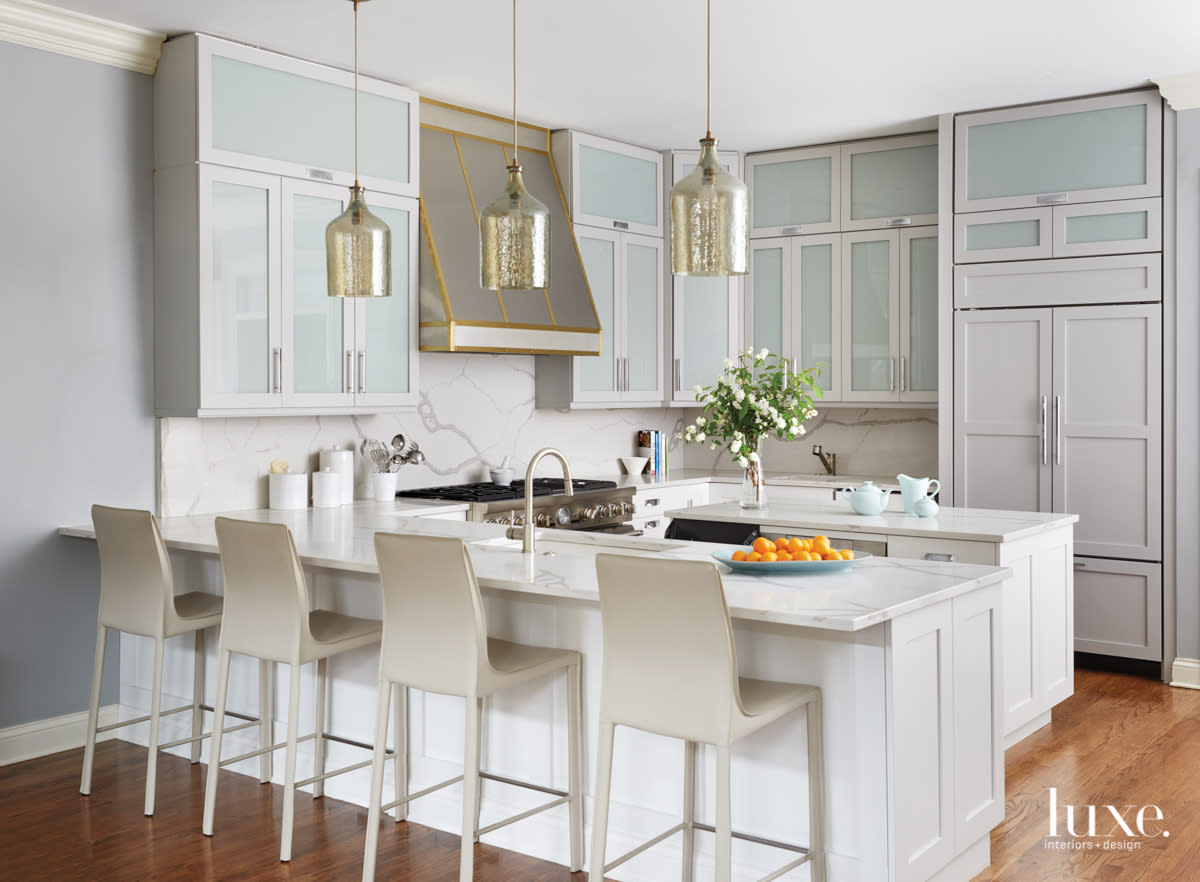 kitchen with marble countertops, an island, custom cabinetry