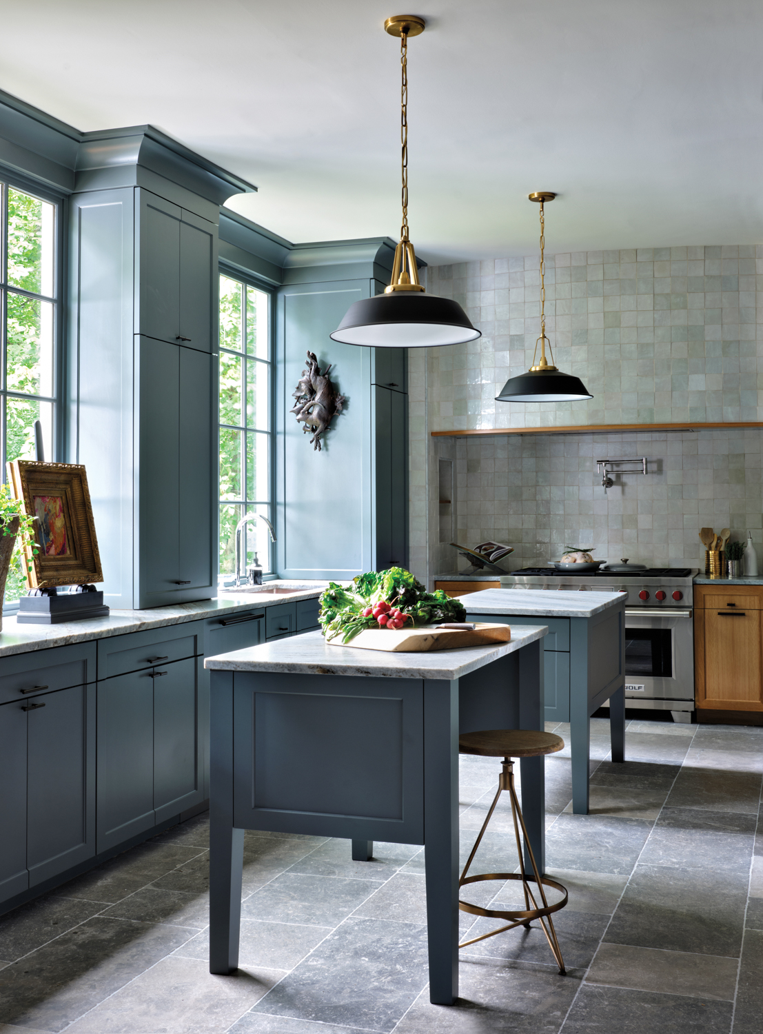 green-grey kitchen with movable islands and wall sconces