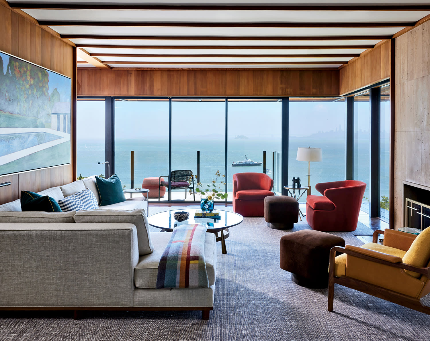 glass walled living room with views of the Pacific Ocean